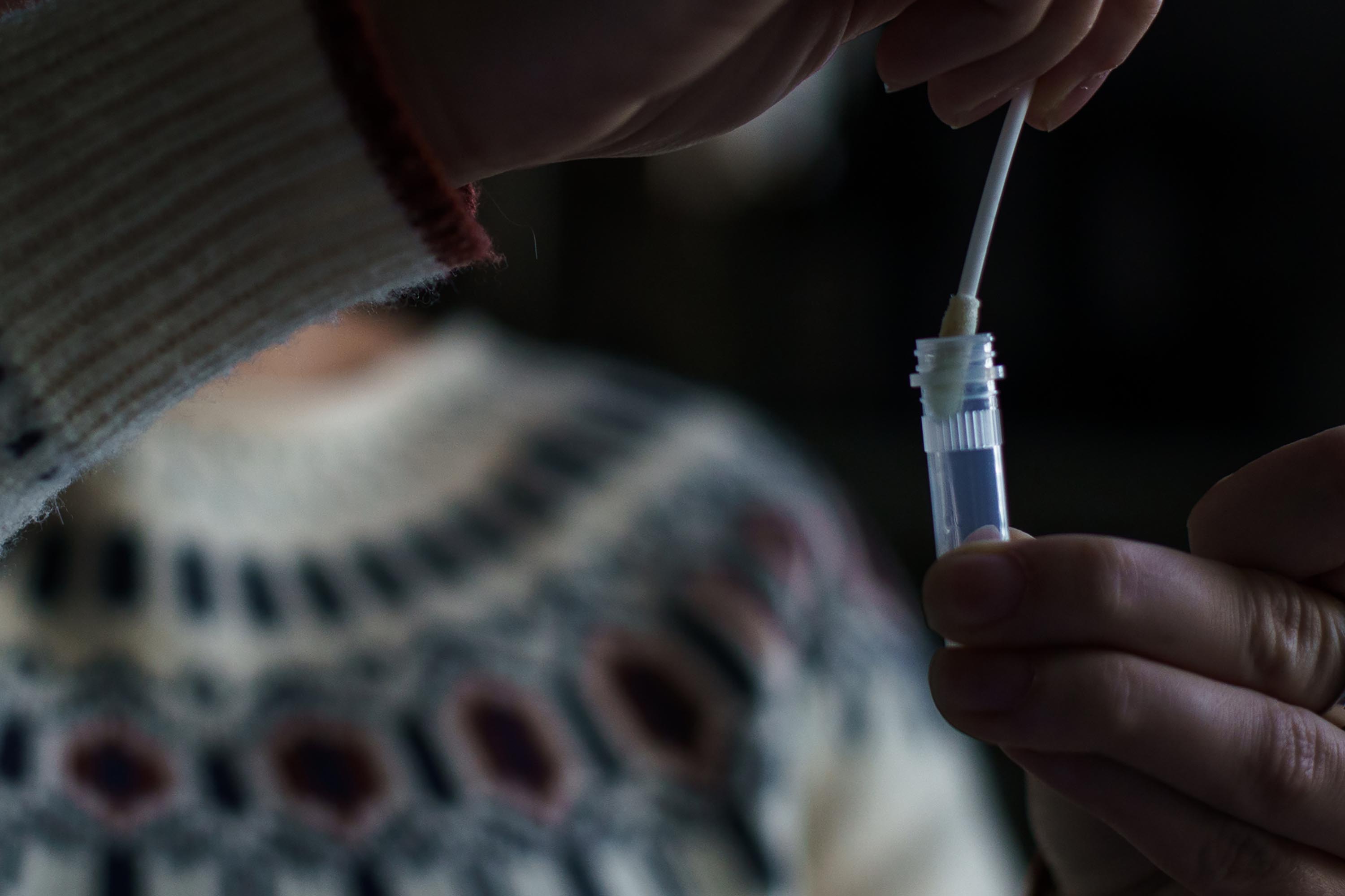 A resident processes a self-administered at-home Covid-19 test, received through a government program, in Easton, New Hampshire, in December 2021.
