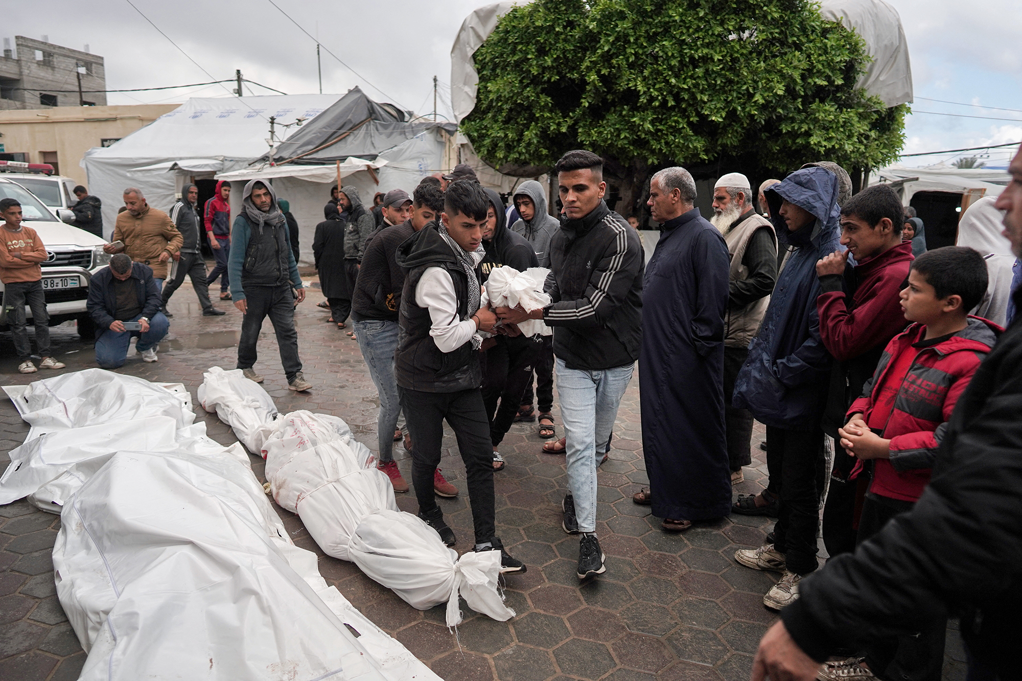 Palestinians carry the bodies of victims killed in overnight Israeli bombardment on the Nuseirat refugee camp in central Gaza during their funeral at the al-Aqsa Martyrs Hospital in Deir el-Balah, Gaza, on April 10.