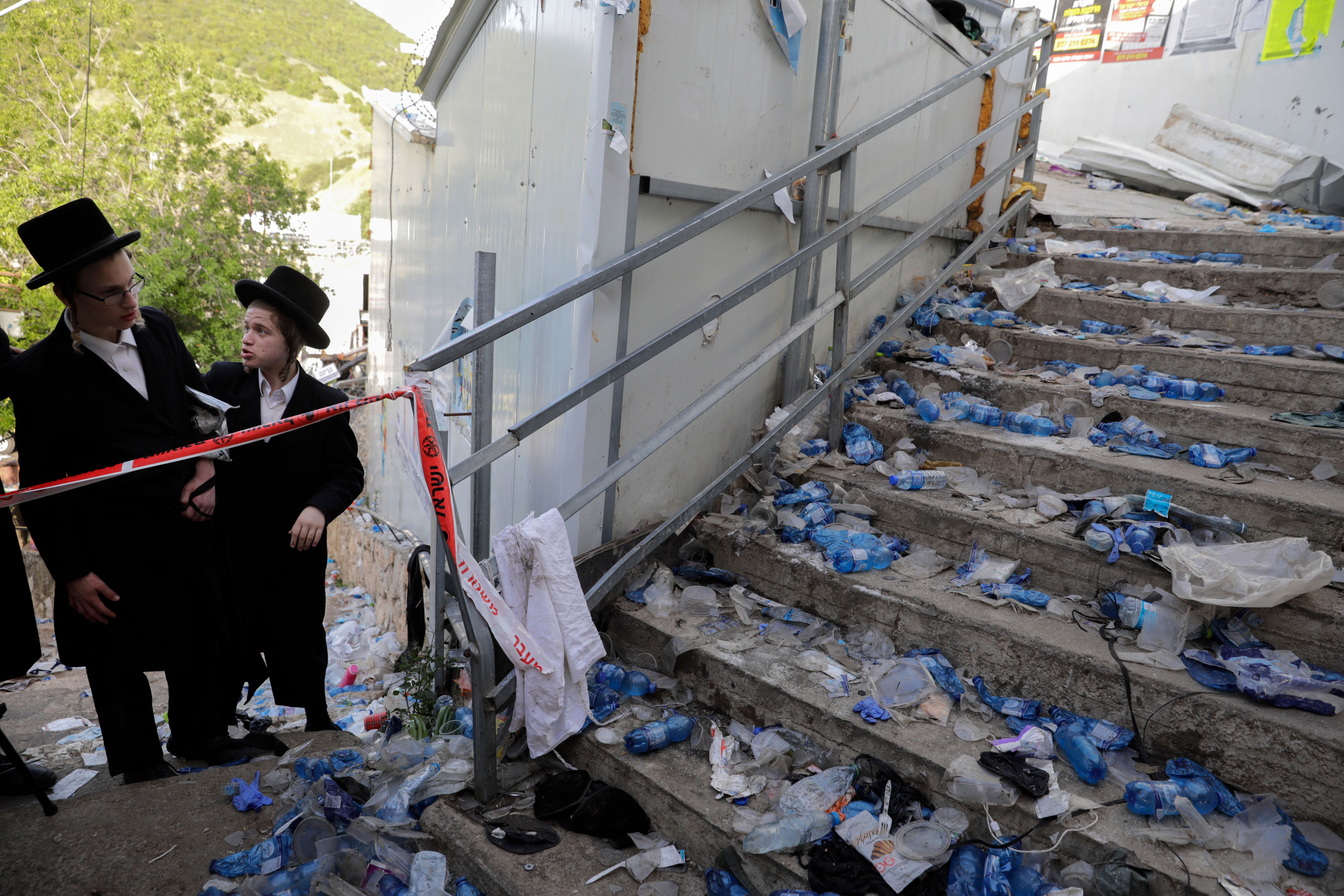 Ultra-Orthodox Jews look at the scene on April 30 following the Lag B'Omer festival on Mount Meron in Israel.