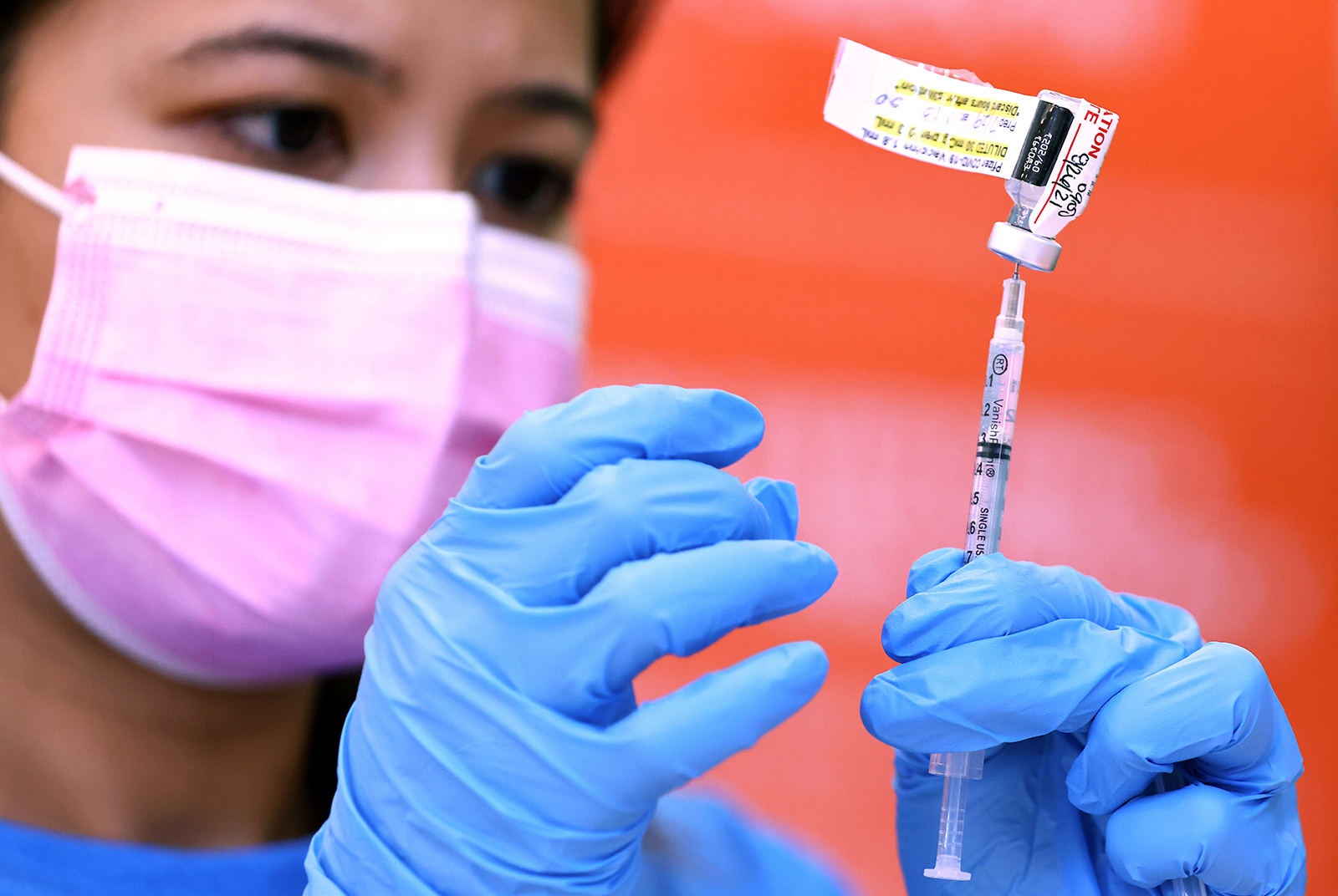 Registered nurse Darryl Hana prepares a dose of the Pfizer vaccine at a three-day vaccination clinic at Providence Wilmington Wellness and Activity Center on July 29, in Wilmington, California. 