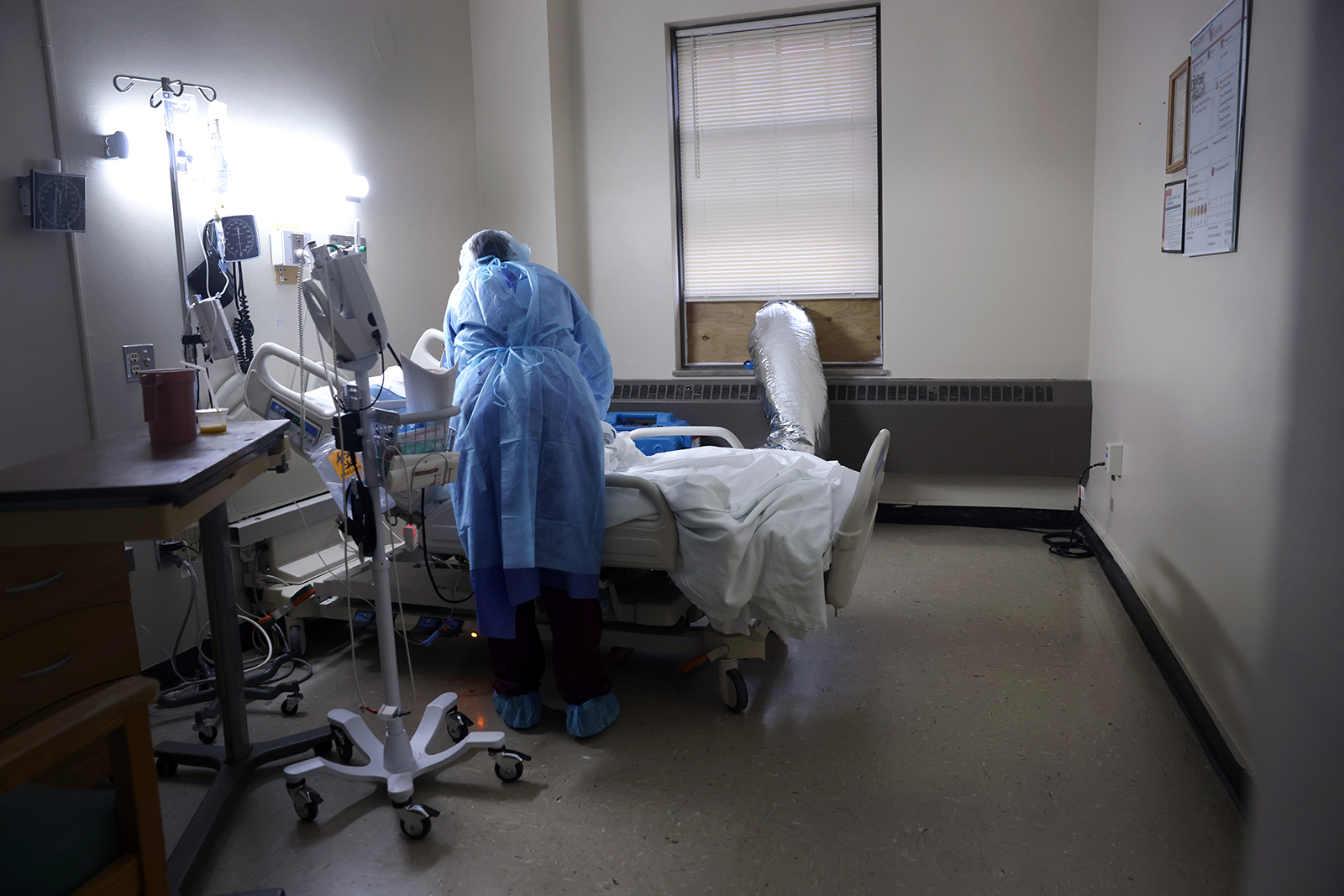 A healthcare professional gets vital information from a Covid-19 patient at Roseland Community Hospital in Chicago, Illinois, on December 17.