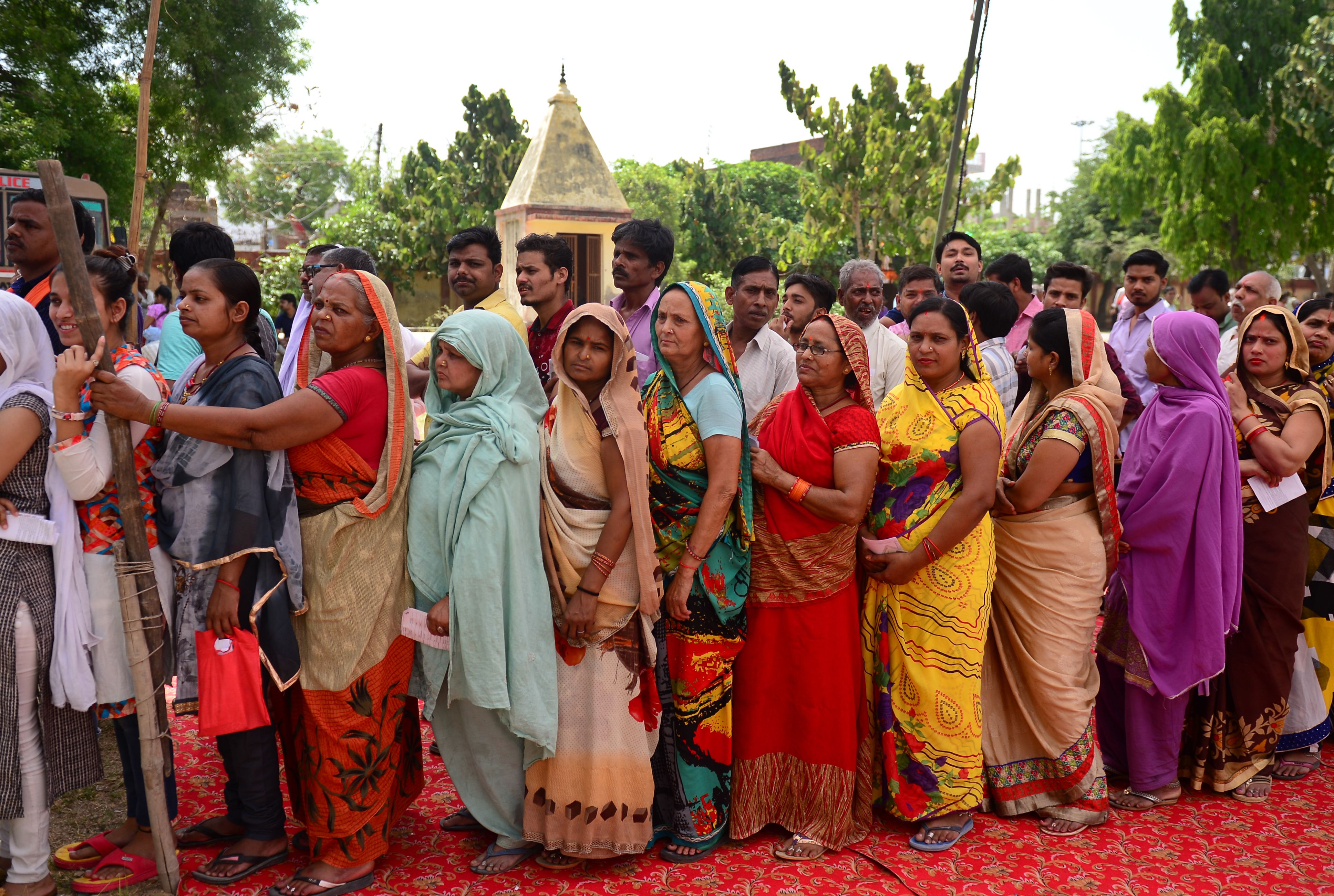 Indian voters queue at a polling station to cast their ballots during the fifth phase of general election in Amethi in Uttar Pradesh state on May 6, 2019. 