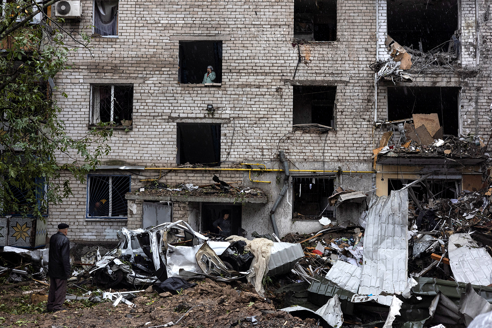 People inspect the damage at a residential building destroyed by a strike in Mykolaiv on September 11.