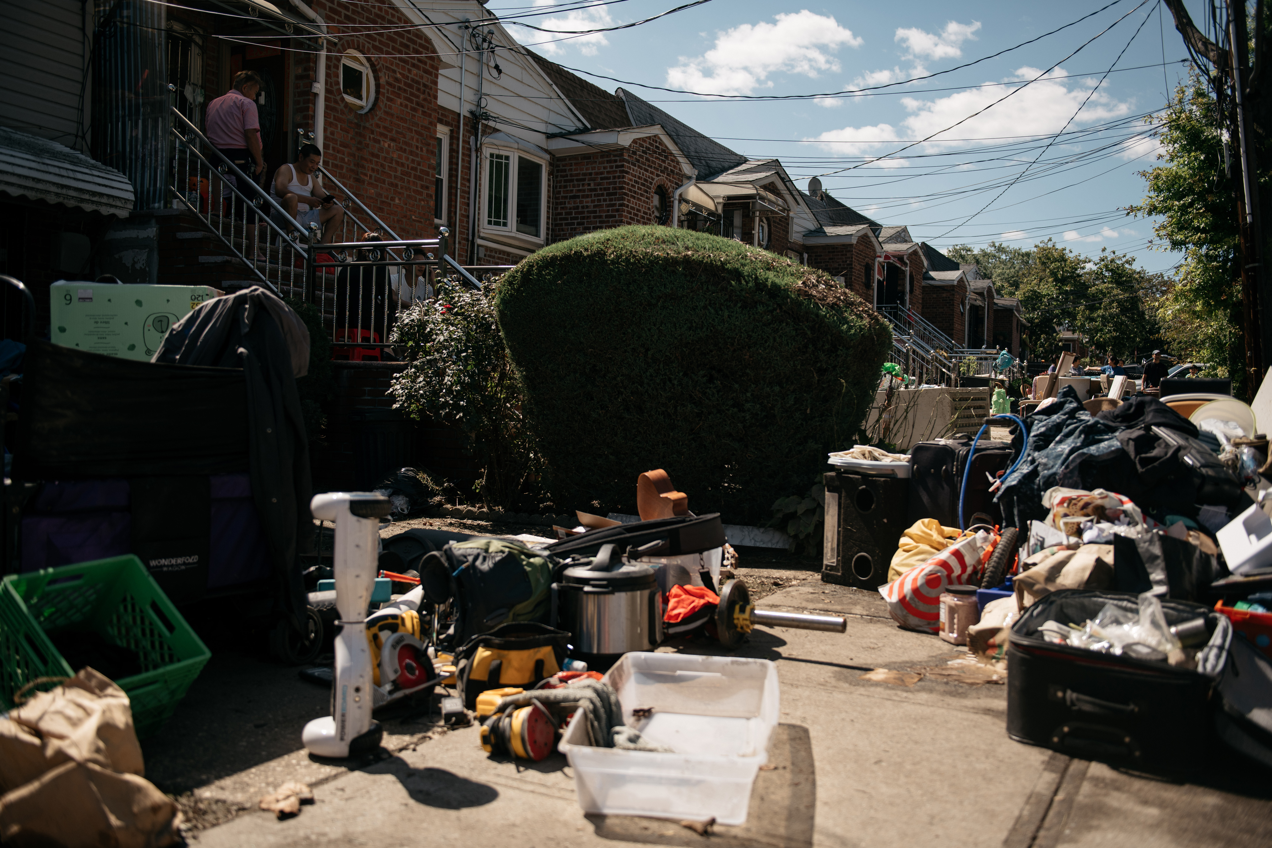 Residents sort through items damaged and destroyed by flooding on Thursday, September 2, in the Flushing neighborhood of Queens, New York City.