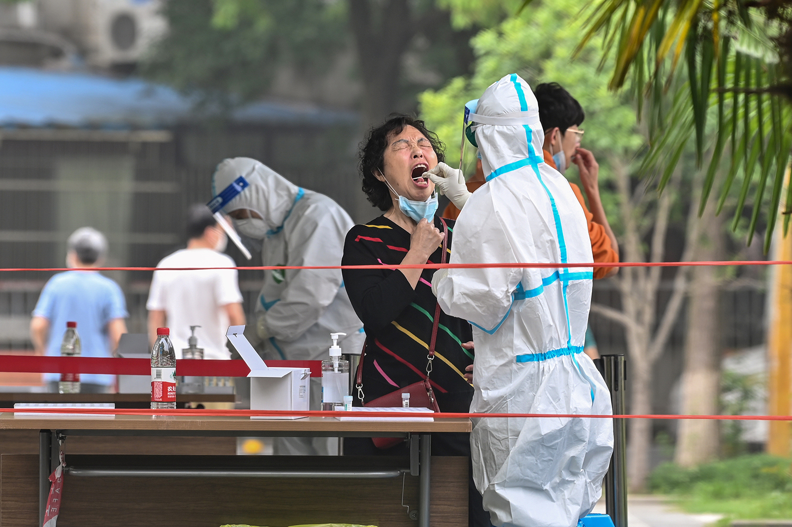 A medical worker takes a swab sample from a woman to be tested for Covid-19 in Wuhan, China on May 15.