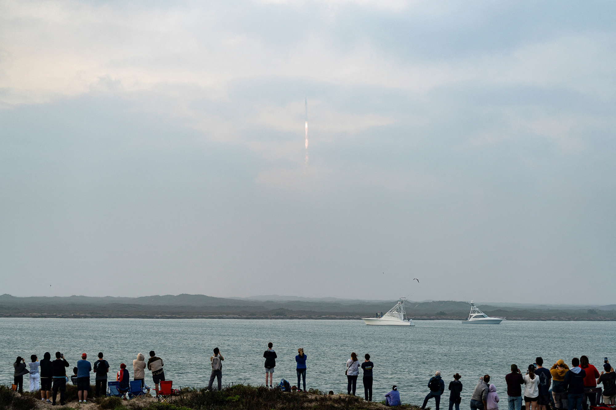 Spectators on South Padre Island watch as SpaceX's next-generation Starship spacecraft lifts off, near Brownsville, Texas, on March 14. 