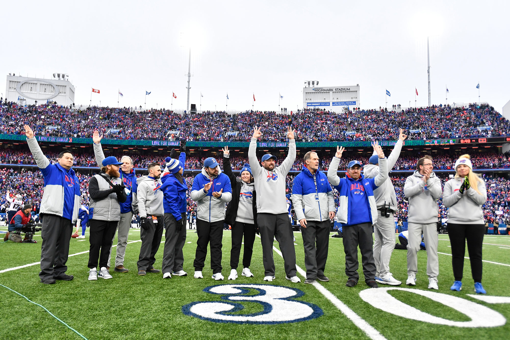 The Buffalo Bills medical team waves to cheering fans on Sunday, January 8.