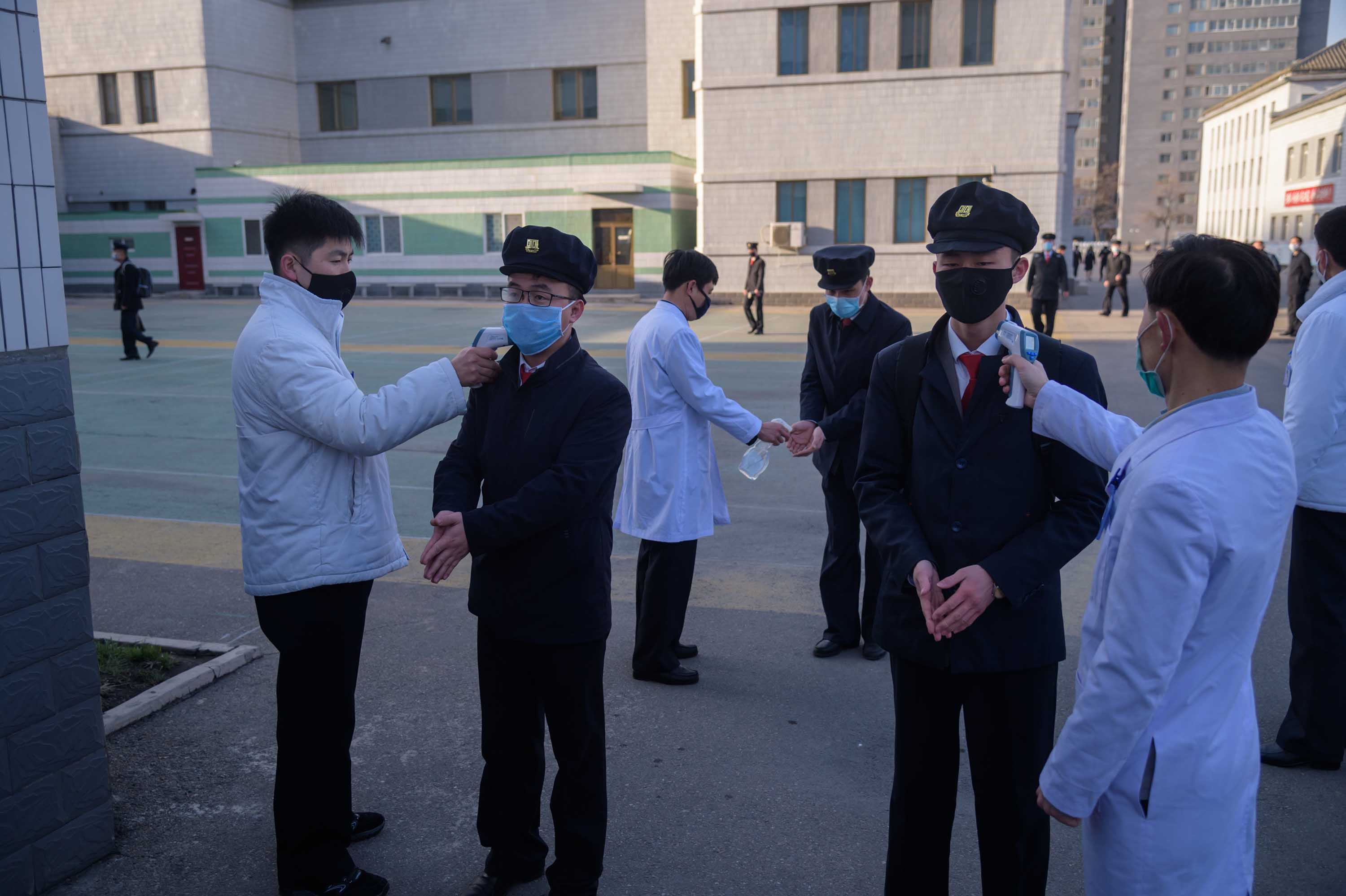 Students wearing face masks disinfect their hands and undergo a temperature check as they arrive for a lecture on preventative measures against coronavirus at the Pyongyang University of Medicine in Pyongyang, North Korea, on April 22.