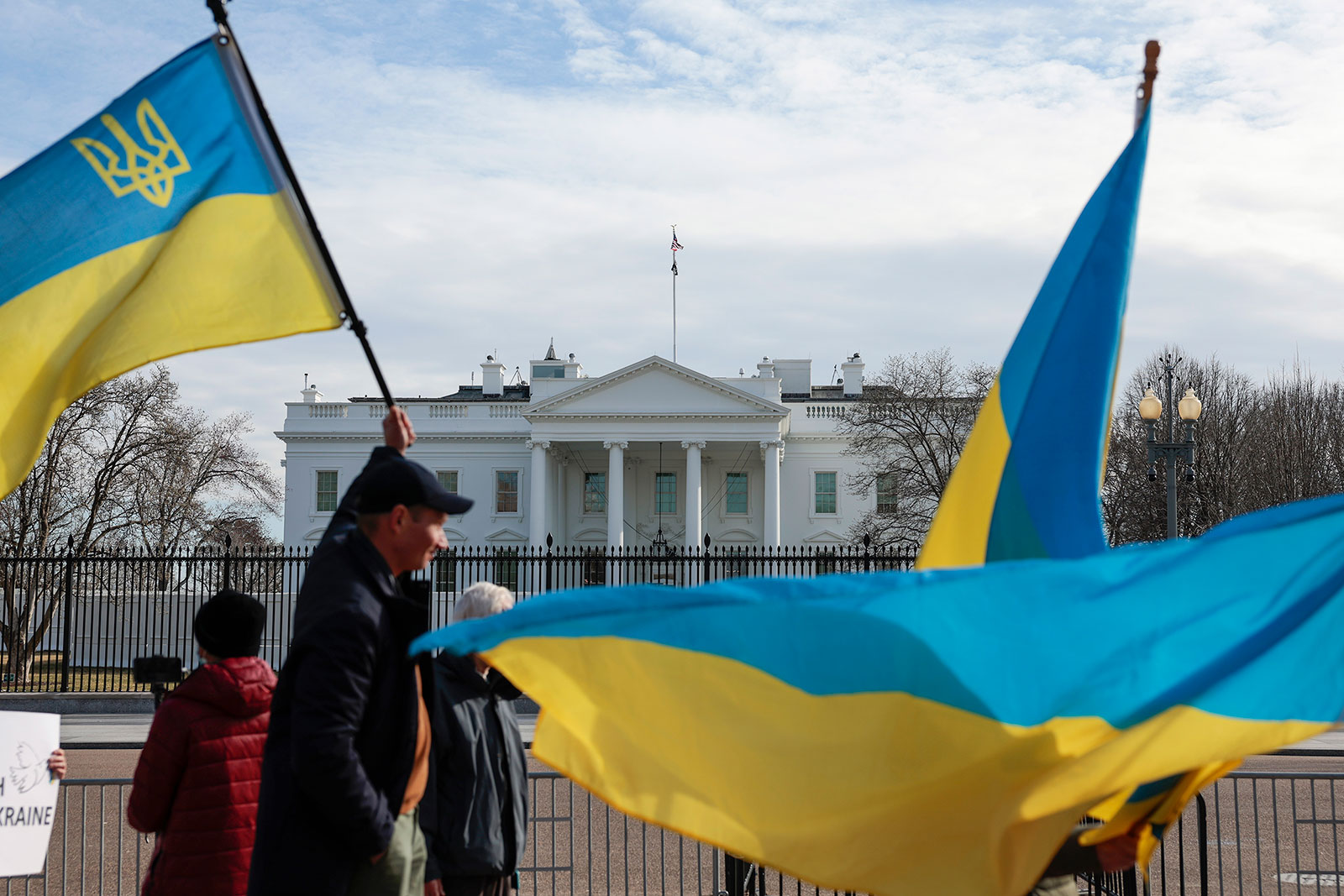People wave Ukrainian flags outside the White House in Washington, DC, on March 1.