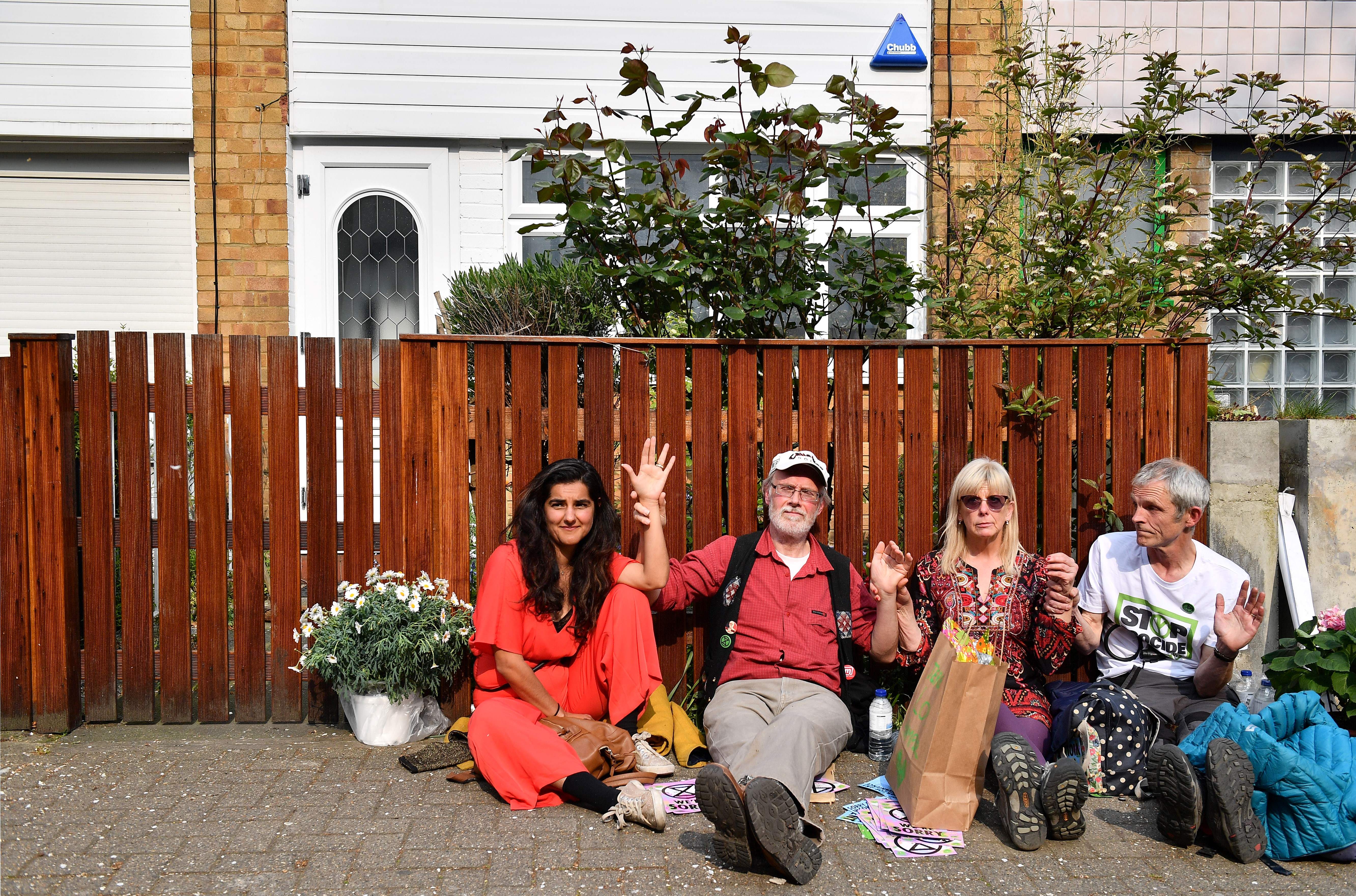 Climate change activists, including Labour party councillor in Stroud Skeena Rathor, pictured left, have glued their hands together and locked themselves to the fence outside the home of Britain's opposition Labour party leader Jeremy Corbyn on the third day of an environmental protest by the Extinction Rebellion group. 