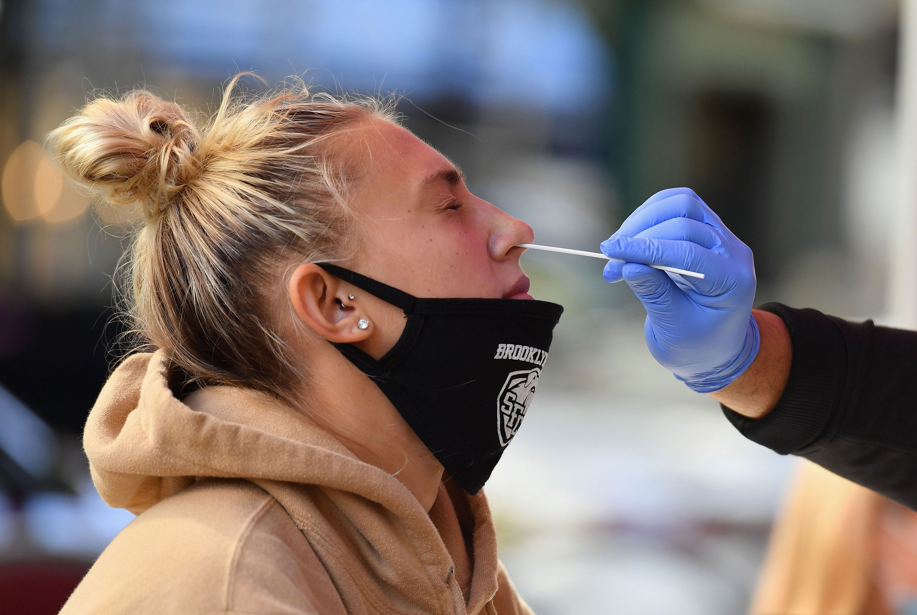 A medical worker takes a nasal swab sample from a student to test for Covid-19 at a pop up testing site in New York on October 8.