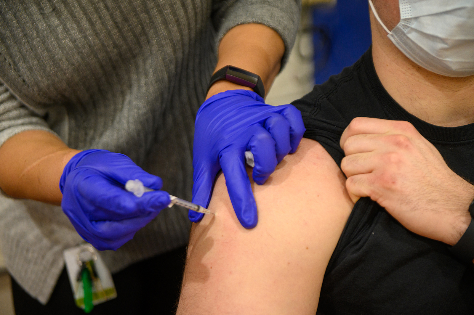 A Holy Name Medical Center healthcare worker administers the Pfizer BioNtech Covid-19 vaccine to a law enforcement officer at the Rodda Community Center in Teaneck, New Jersey, on January 13.