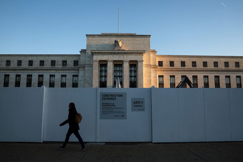 A pedestrian walks past the Federal Reserve Headquarters on March 21, 2023, in Washington, DC. 
