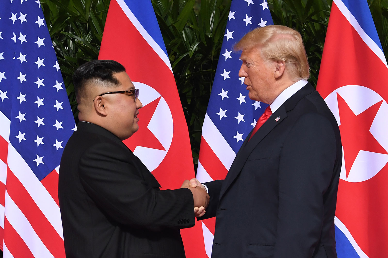 Kim and Trump shake hands during their first summit in Singapore. 