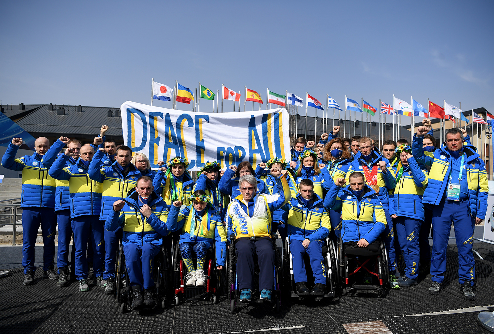 Ukrainian paralympic committee president Valerii Sushkevych and members of Team Ukraine hold a banner up reading 'Peace for All' in the athletes village during day six of the Beijing 2022 Winter Paralympics on March 10 in Zhangjiakou, China. 