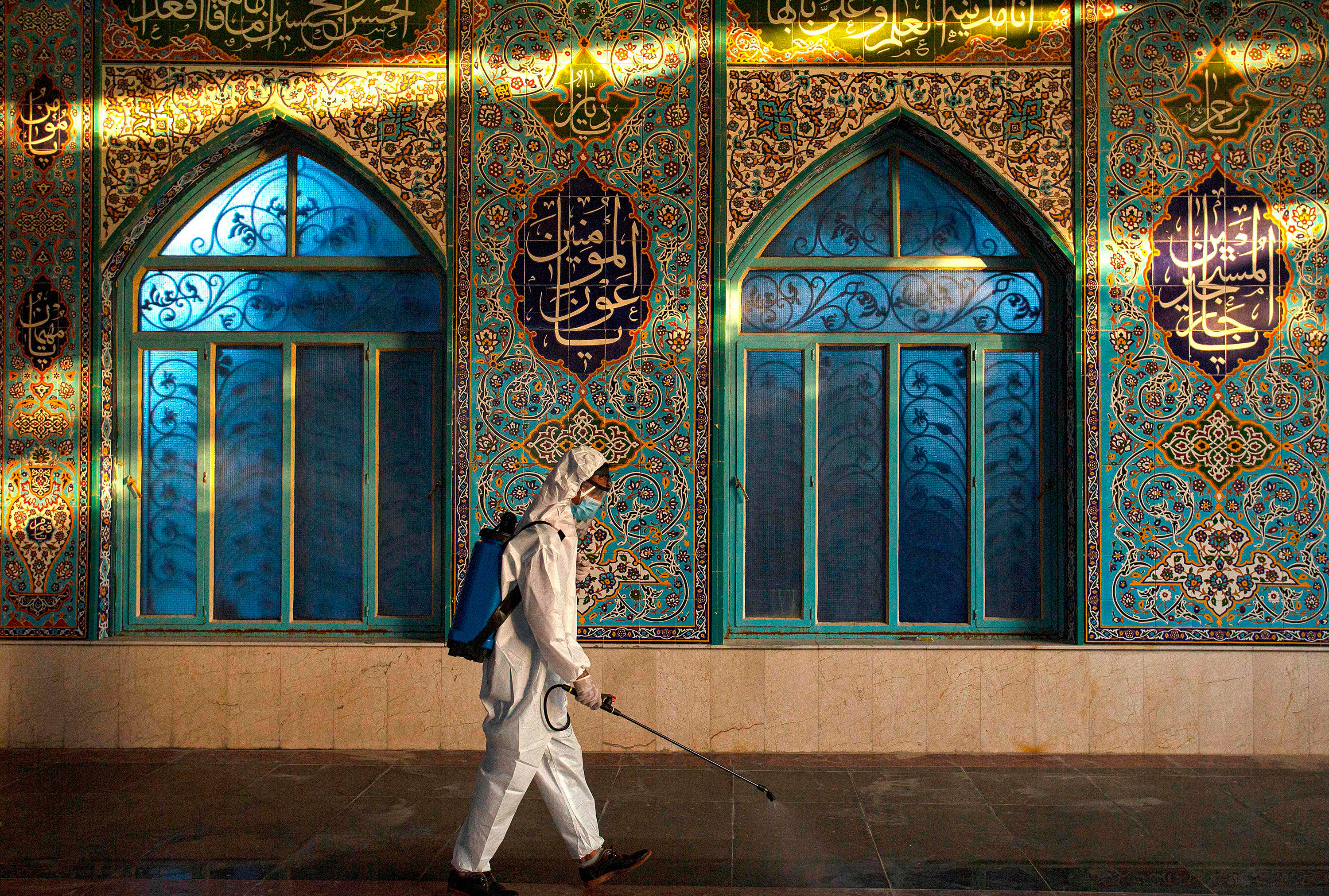 A worker disinfects a mosque on August 20, 2020 in Basra, Iraq