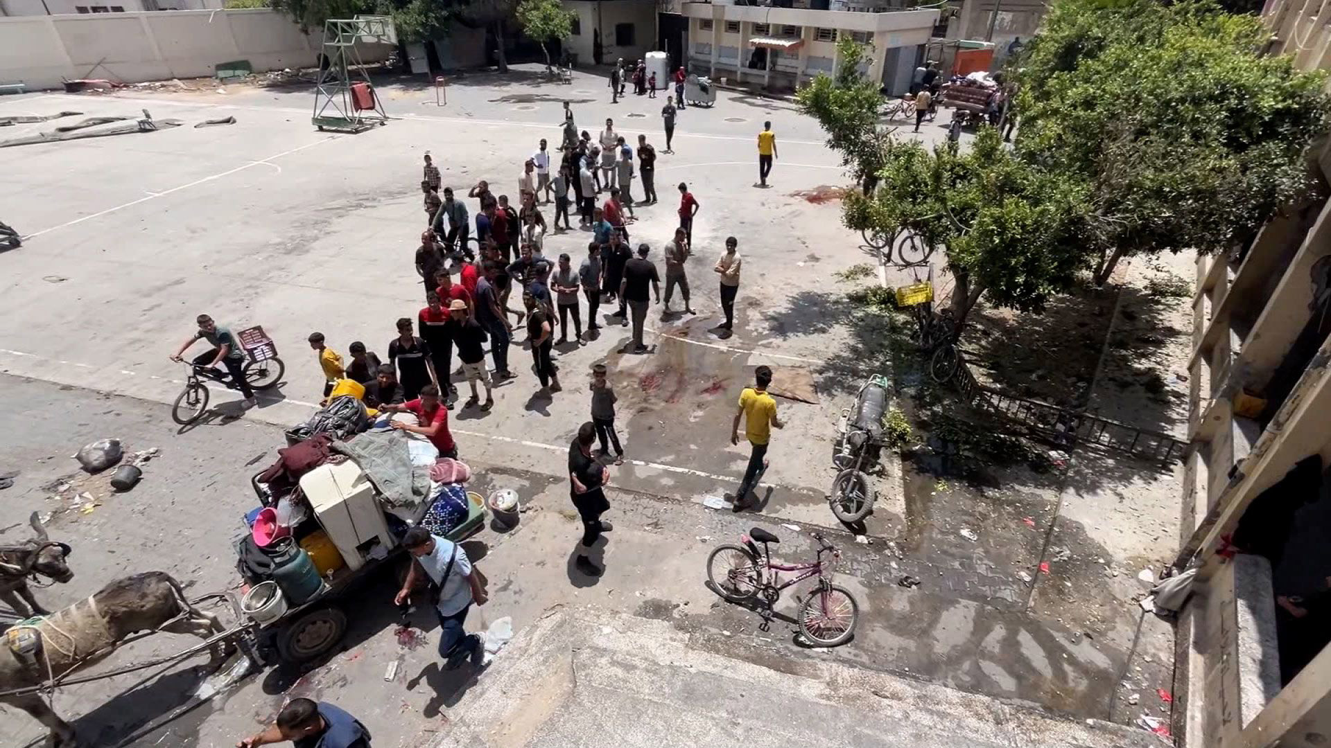 People are seen in the aftermath of a drone strike at Al-Nazla school on the outskirts of Jabaliya, on May 25, 2024.