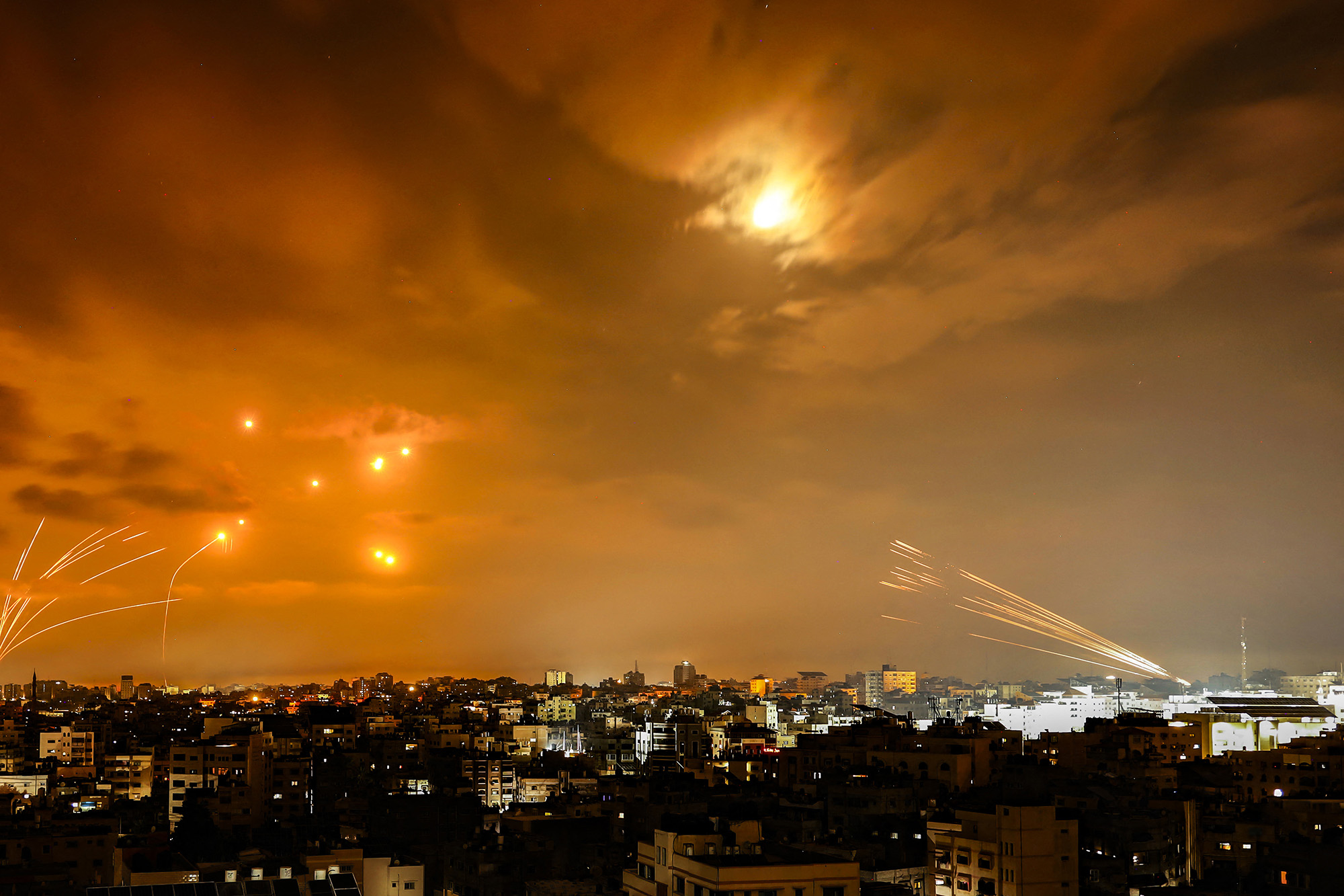 Rockets fired by Palestinian militants from Gaza City are intercepted by the Israeli Iron Dome defence missile system in the early hours of October 8.