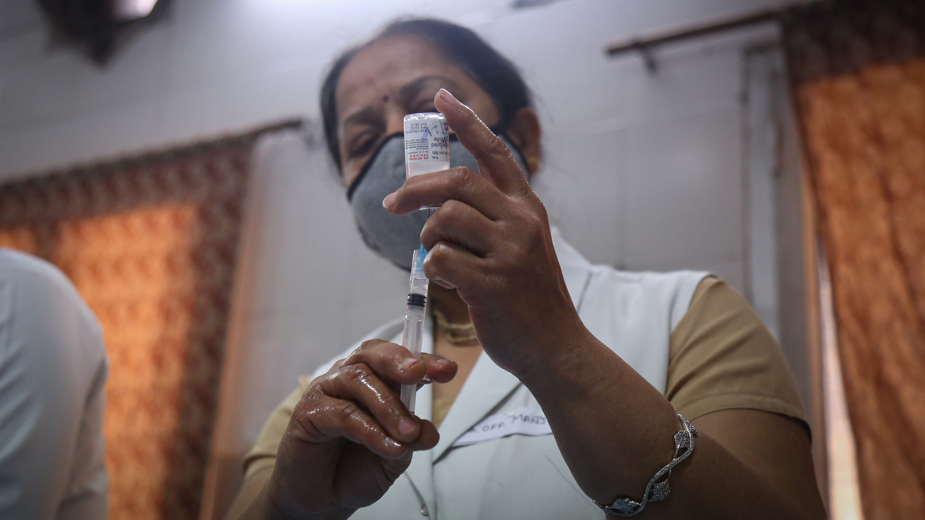 A medic prepares a dose of the Covaxin vaccine at Hindu Rao Hospital on February 16, in New Delhi, India. 