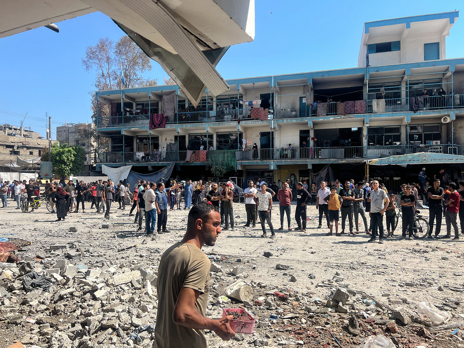 Palestinians inspect the site of an Israeli strike on a UN-run school sheltering displaced people at the Nuseirat refugee camp in central Gaza on Thursday, June 6. 