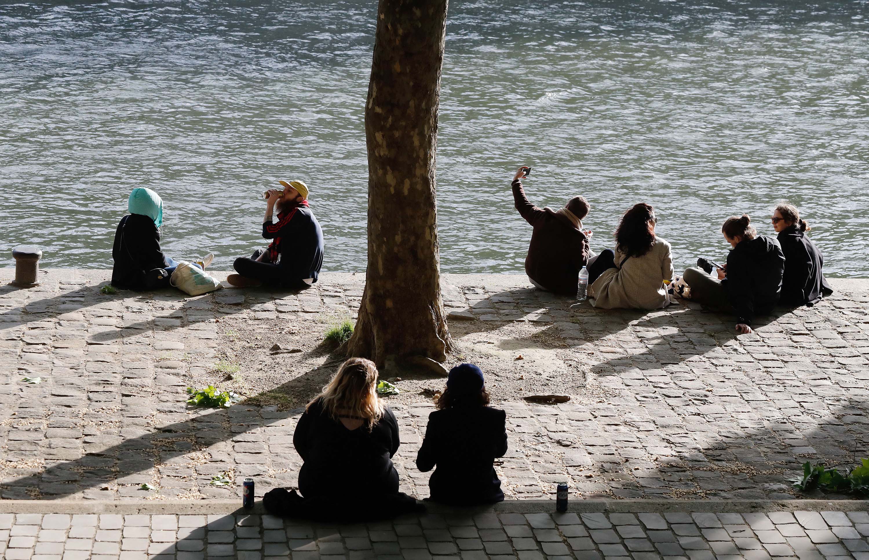 People gather along the banks of the river Seine in Paris on May 11, as France eased lockdown measures.