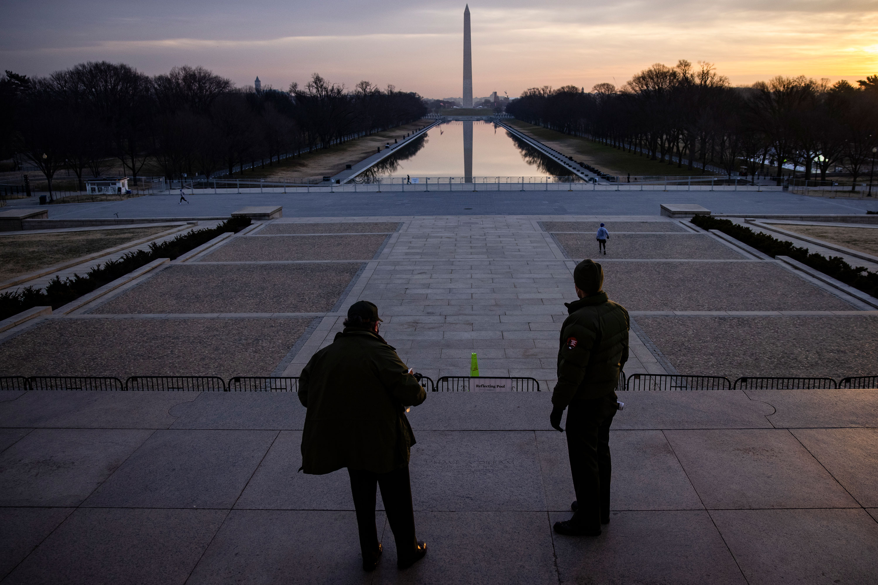 U.S. Park Rangers look out over the National Mall from the steps of the Lincoln Memorial on January 15.