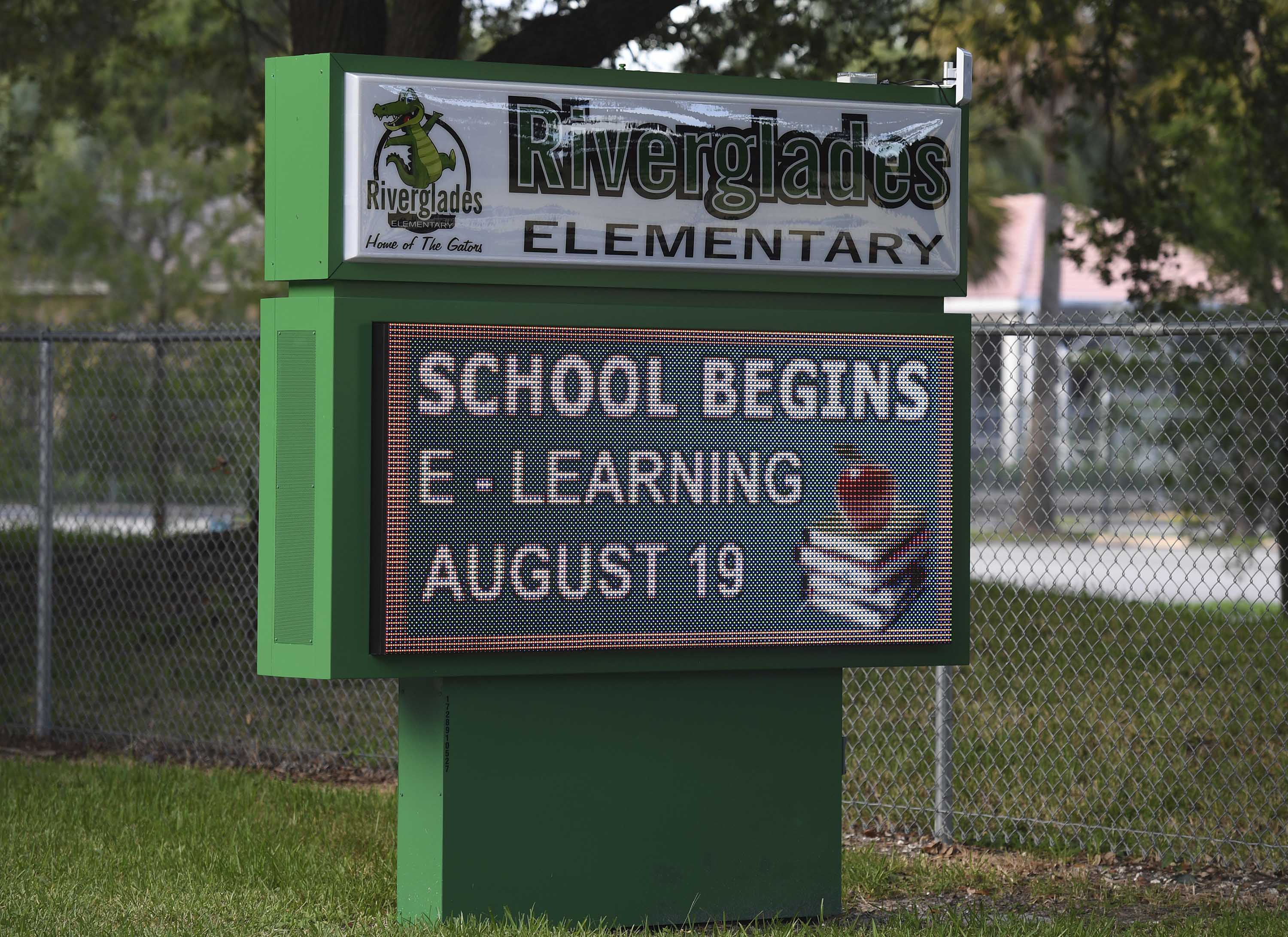 A sign with information about 'eLearning' is pictured outside Riverglades Elementary School in Pompano Beach, Florida, on August 11.