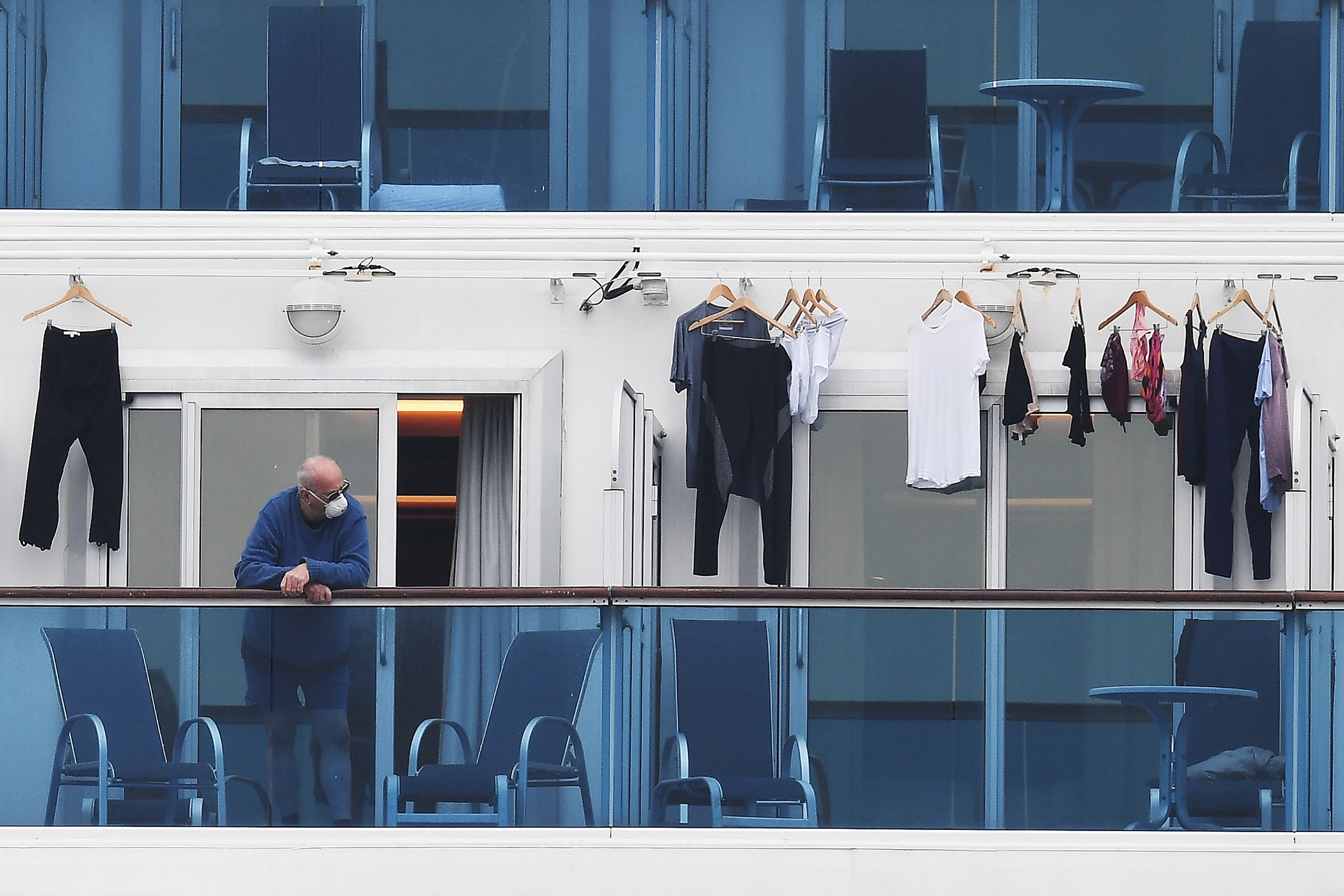 A passenger is seen on a balcony of the Diamond Princess cruise ship in Yokohama on February 14.