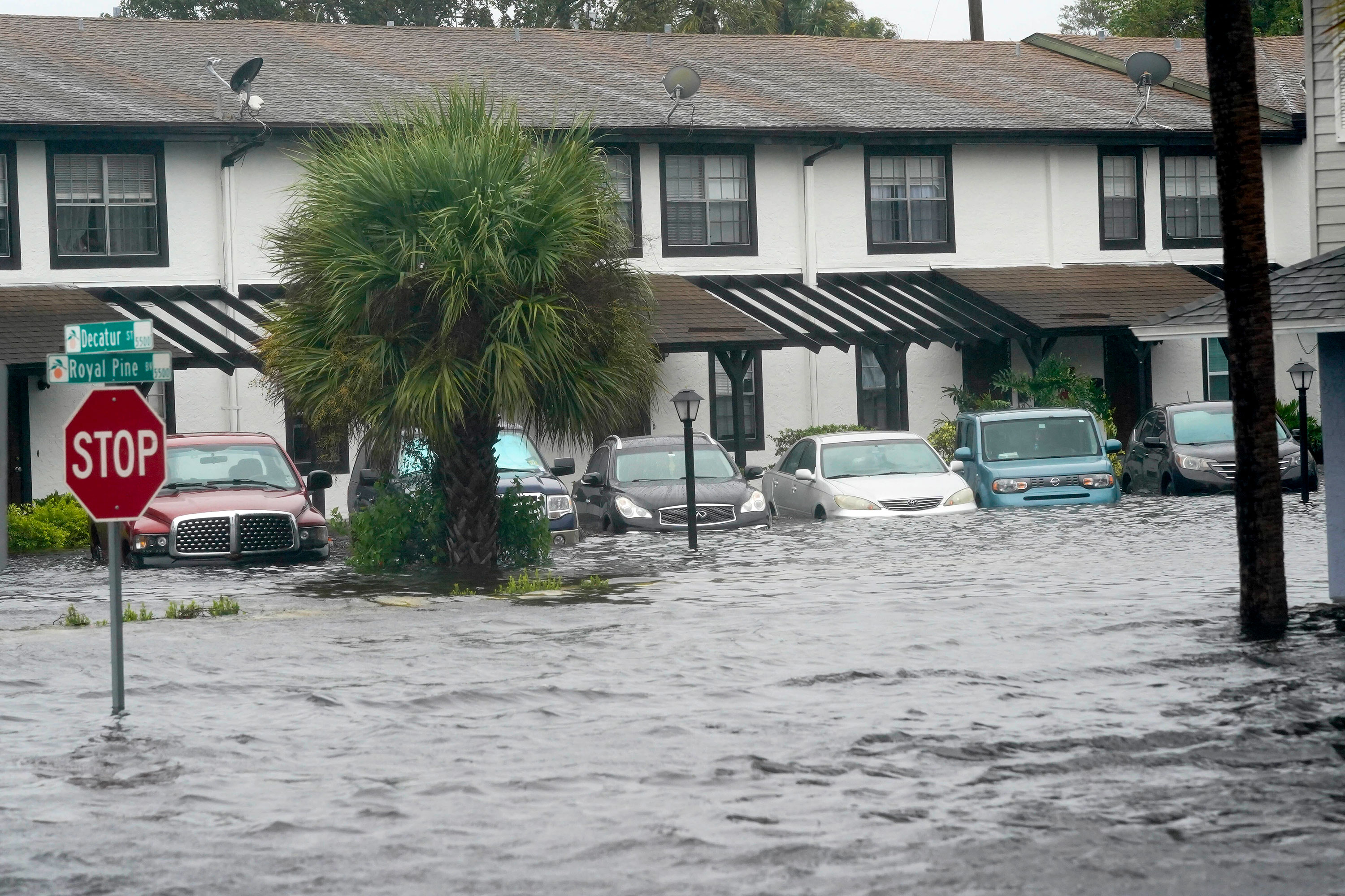 Vehicles sit in floodwaters at the Palm Isle apartments in Orlando, Florida, on Thursday.