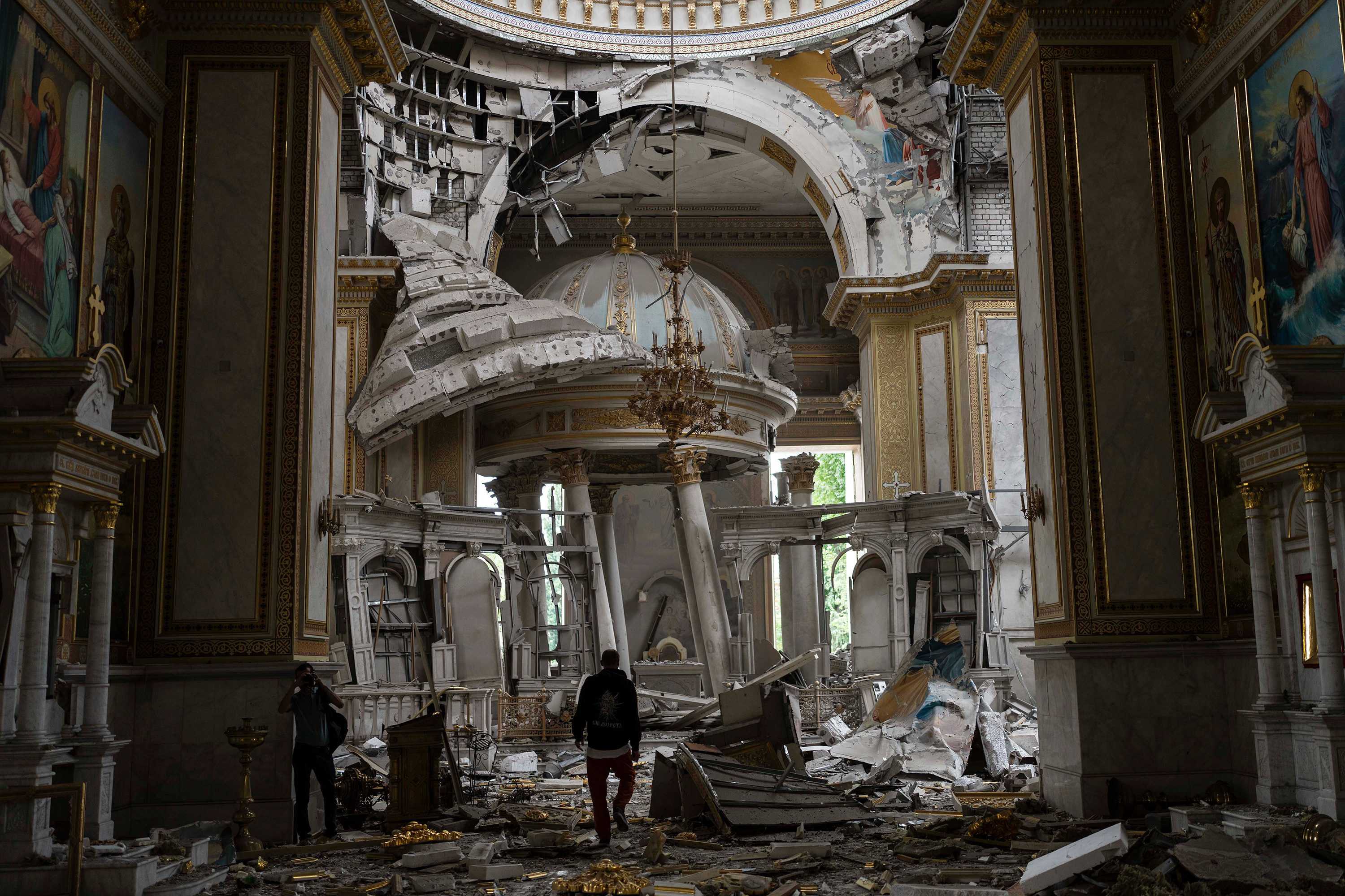 People inspect damages inside the Transfiguration Cathedral in Odesa, Ukraine, on Sunday, July 23. 