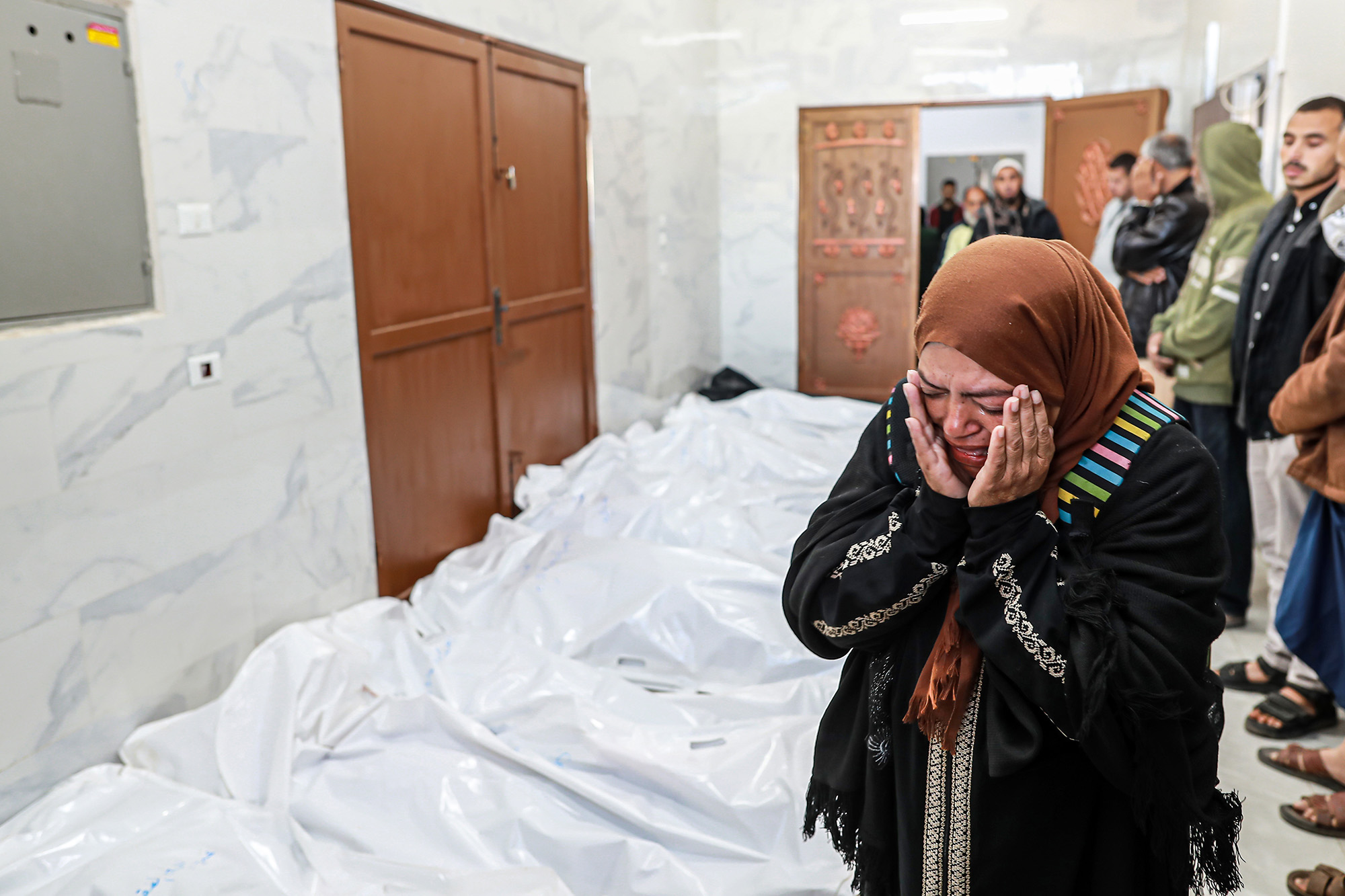 Relatives mourn as bodies are brought to the morgue of European Hospital in Khan Younis, Gaza, on March 5.