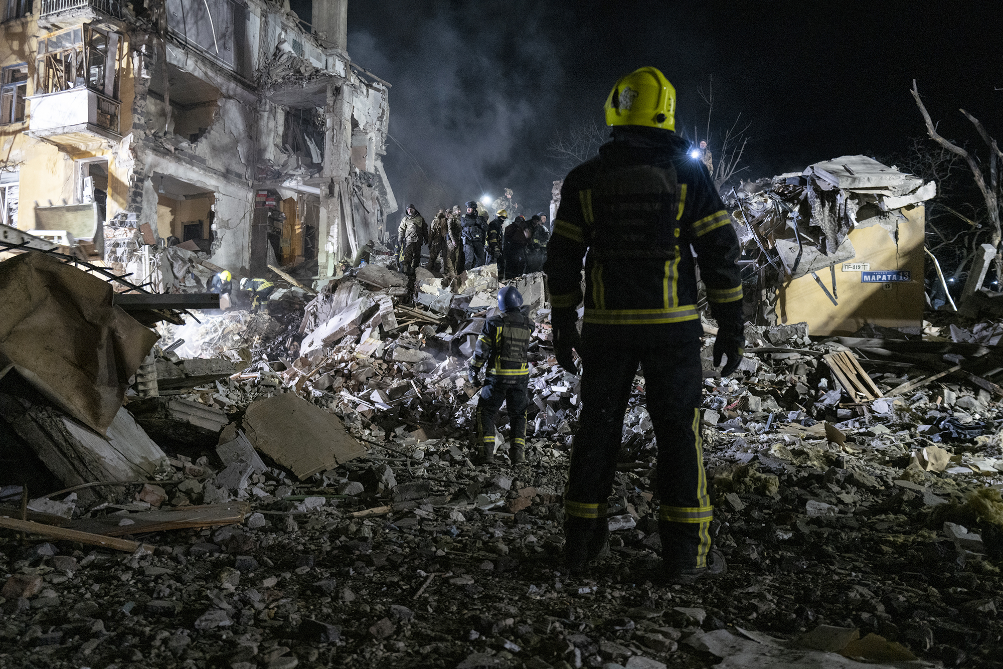 Rescue workers conduct search and rescue operations after a Russian missile hits a residential building in Kramatorsk, Ukraine, on February 1.