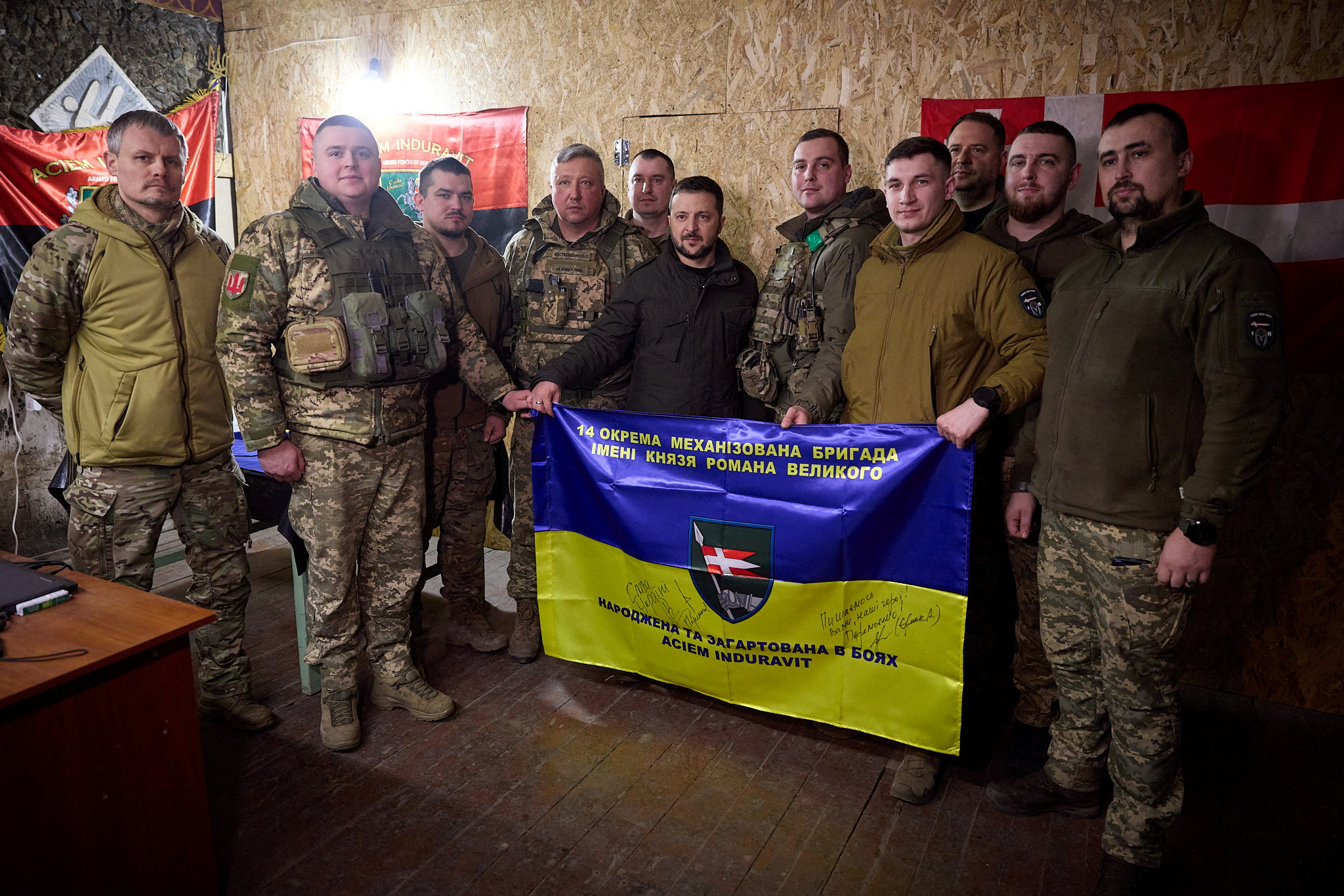 Ukraine's President Volodymyr Zelensky, center, poses for a picture with Ukrainian servicemen as he visits their position in a front line near Kupiansk, Kharkiv region, in Ukraine on February 19.