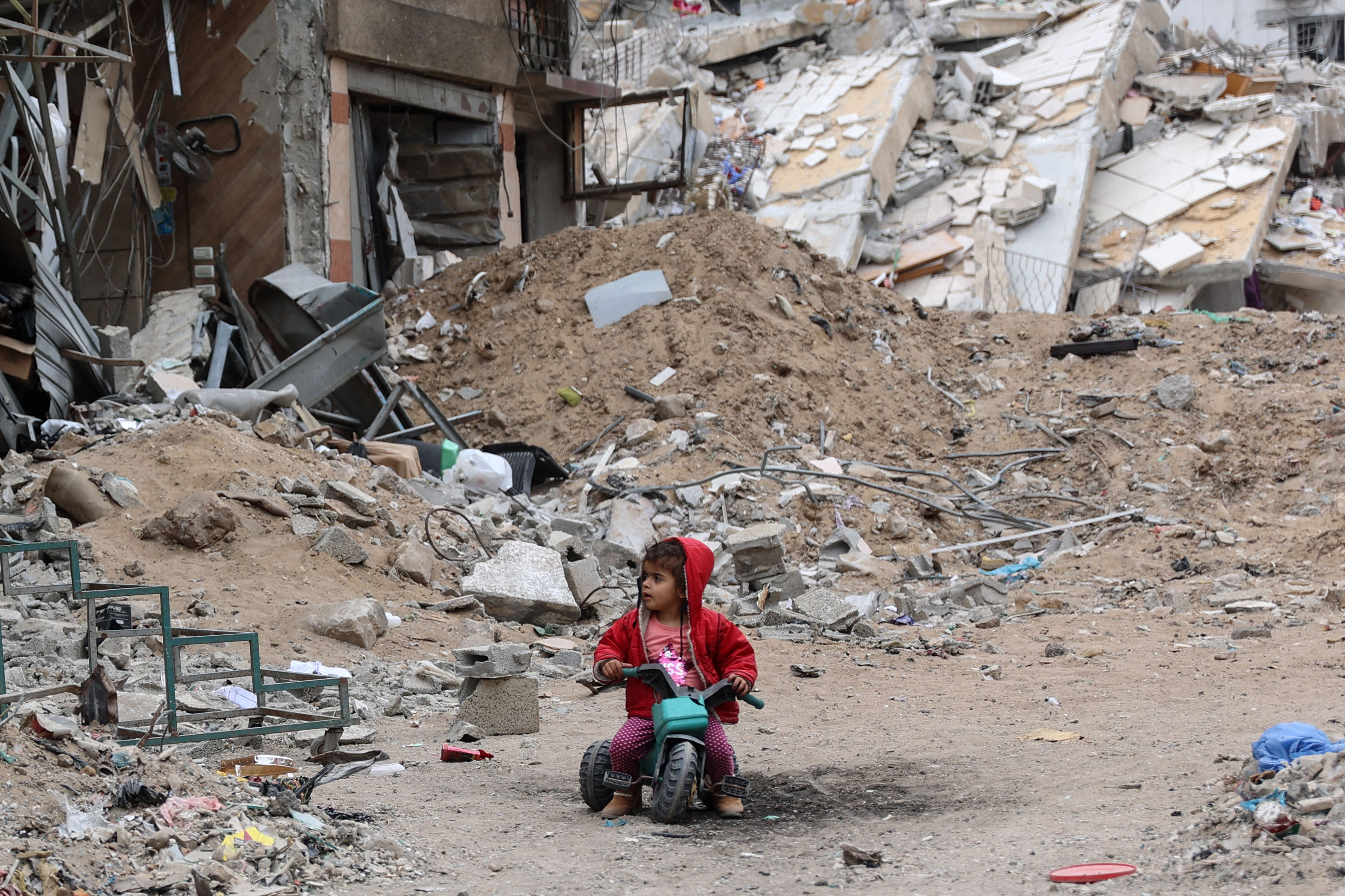 A Palestinian child plays near a building destroyed by earlier Israeli bombardment in Gaza City on April 8.