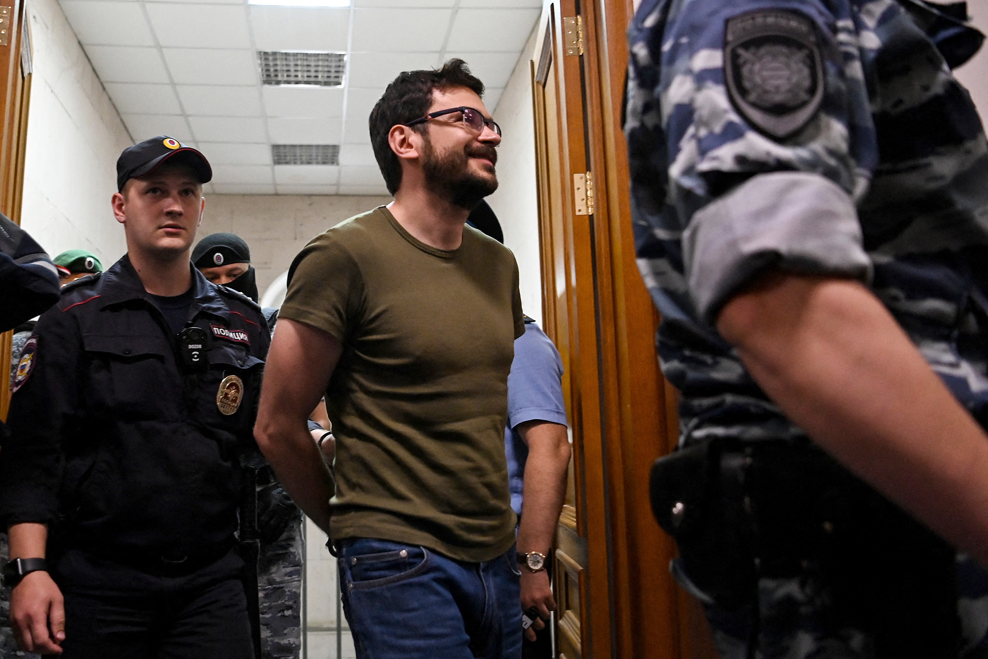 Russian opposition figure and former Moscow city councillor Ilya Yashin is escorted inside the Basmanny district court prior to a hearing on his detention in Moscow, Russia, on July 13.