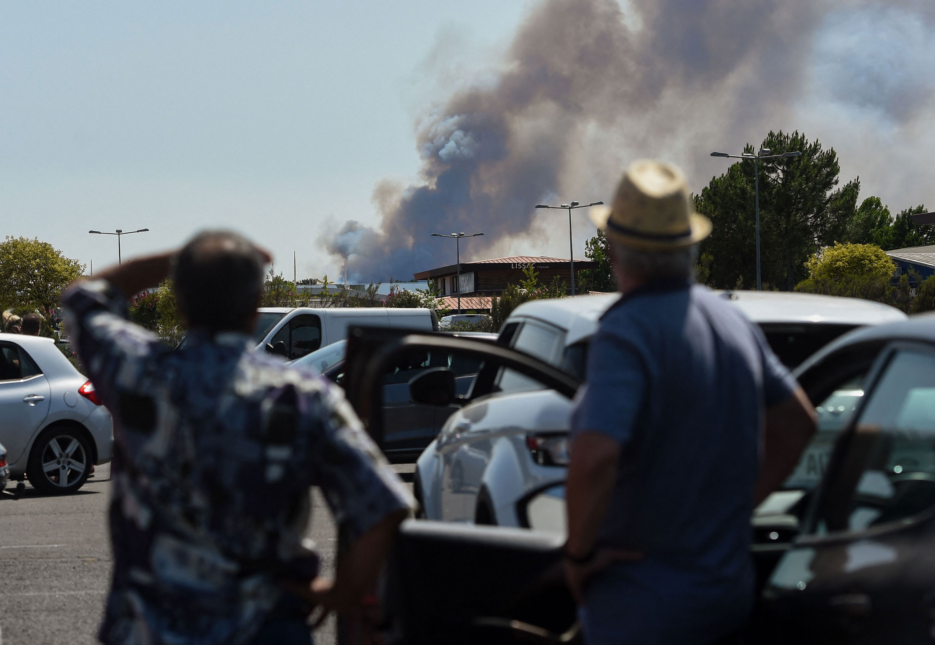 People watch smoke rise from Teste-de-Buch, France, on July 16.