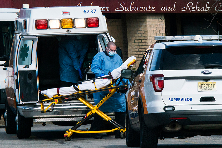 Medical workers prepare to transport a patient from Andover Subacute and Rehabilitation Center while wearing masks and personal protective equipment on Thursday, April 16, 2020 in Andover, New Jersey. 