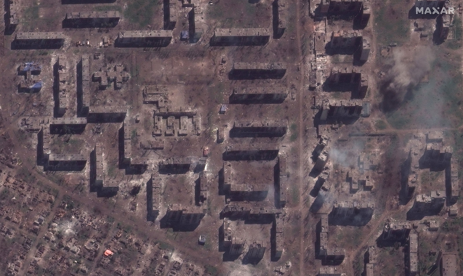 A damaged school and smoldering apartment buildings seen on May 15, 2023. 