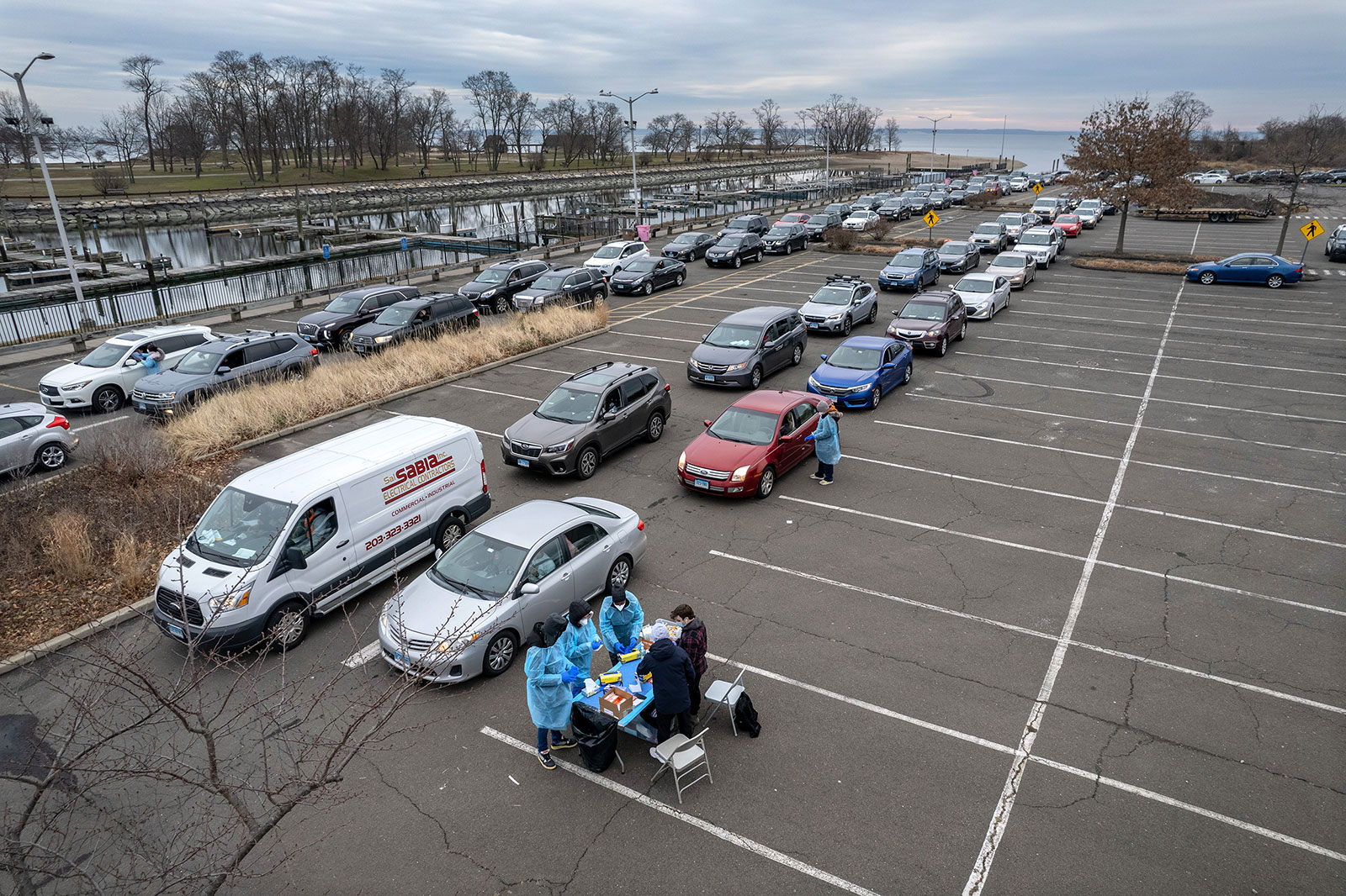 Health workers administer Covid-19 tests at a drive-through testing site in Stamford, Connecticut, on December 28.