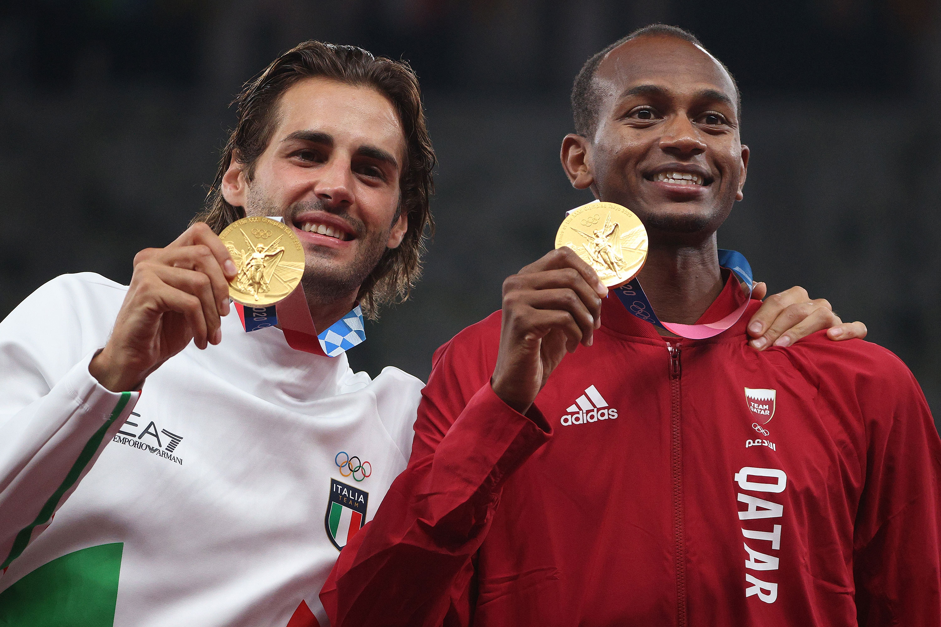Joint gold medalists Gianmarco Tamberi of Italy and Mutaz Essa Barshim of Qatar celebrate on the podium together on August 2.