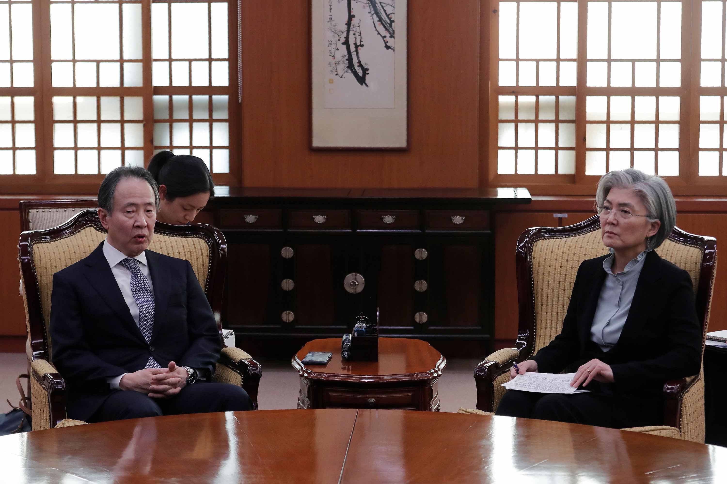 Japan's ambassador to South Korea Koji Tomita, left, meets with South Korea's Foreign Minister Kang Kyung-wha at the foreign ministry in Seoul, South Korea, on Friday.