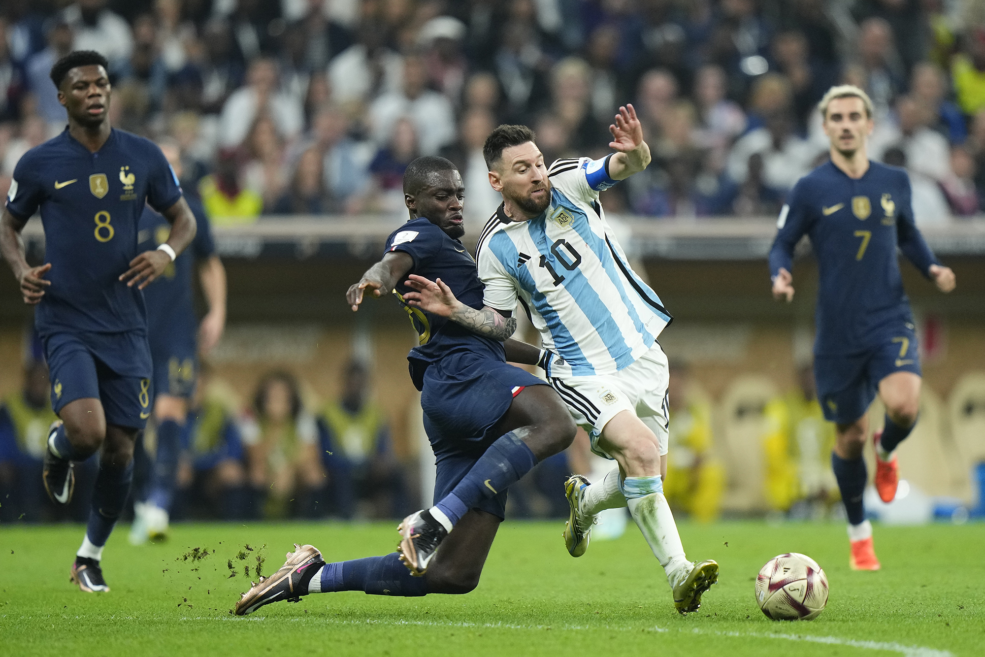 Messi tries to avoid a tackle from Upamecano.