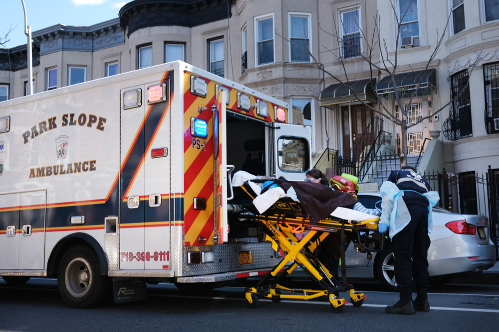 Health workers carry a patient to an ambulance on April 11 in the Brooklyn borough of New York City.
