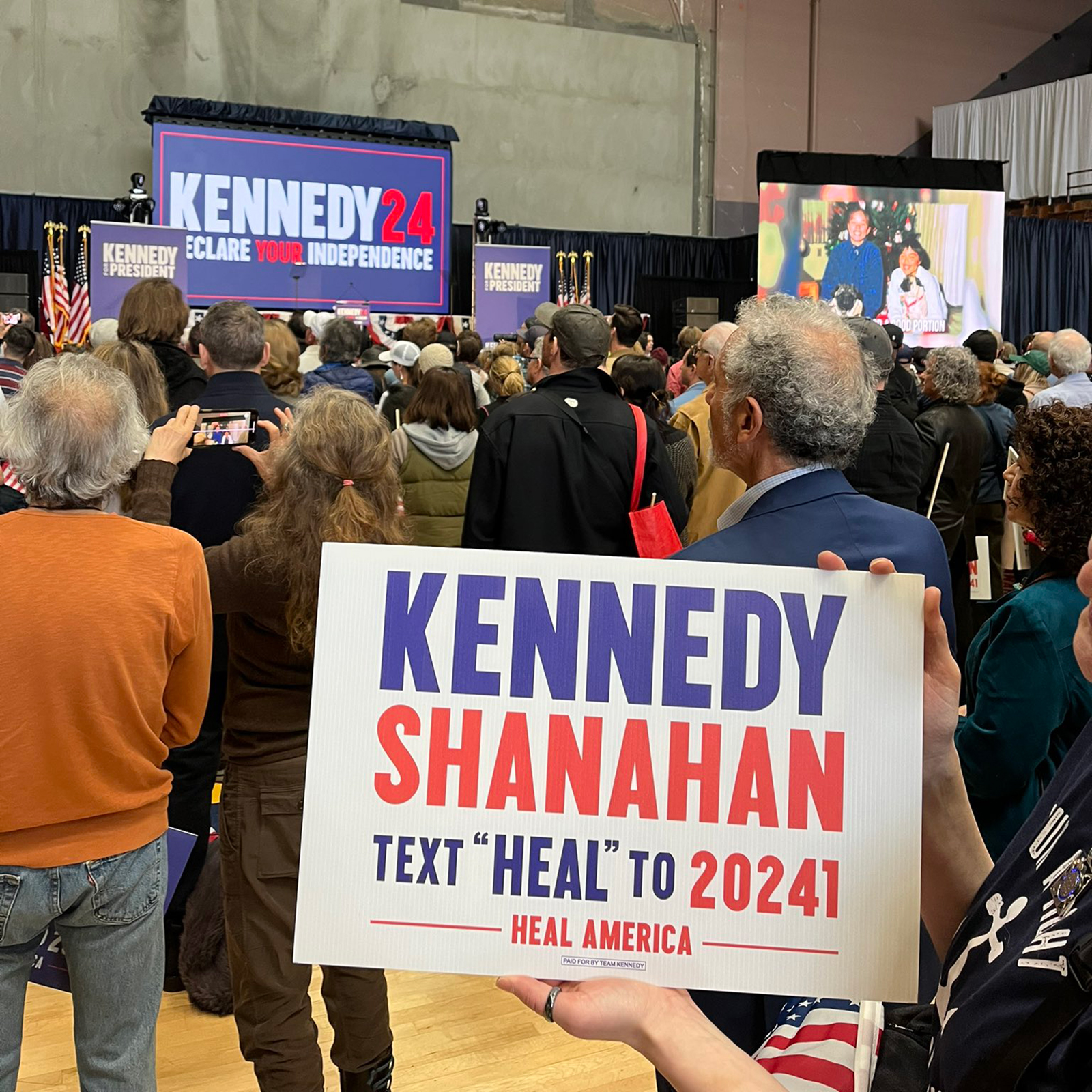 A supporter of Robert F. Kennedy Jr. holds a "Kennedy Shanahan" sign at his rally in Oakland, California, on Tuesday.