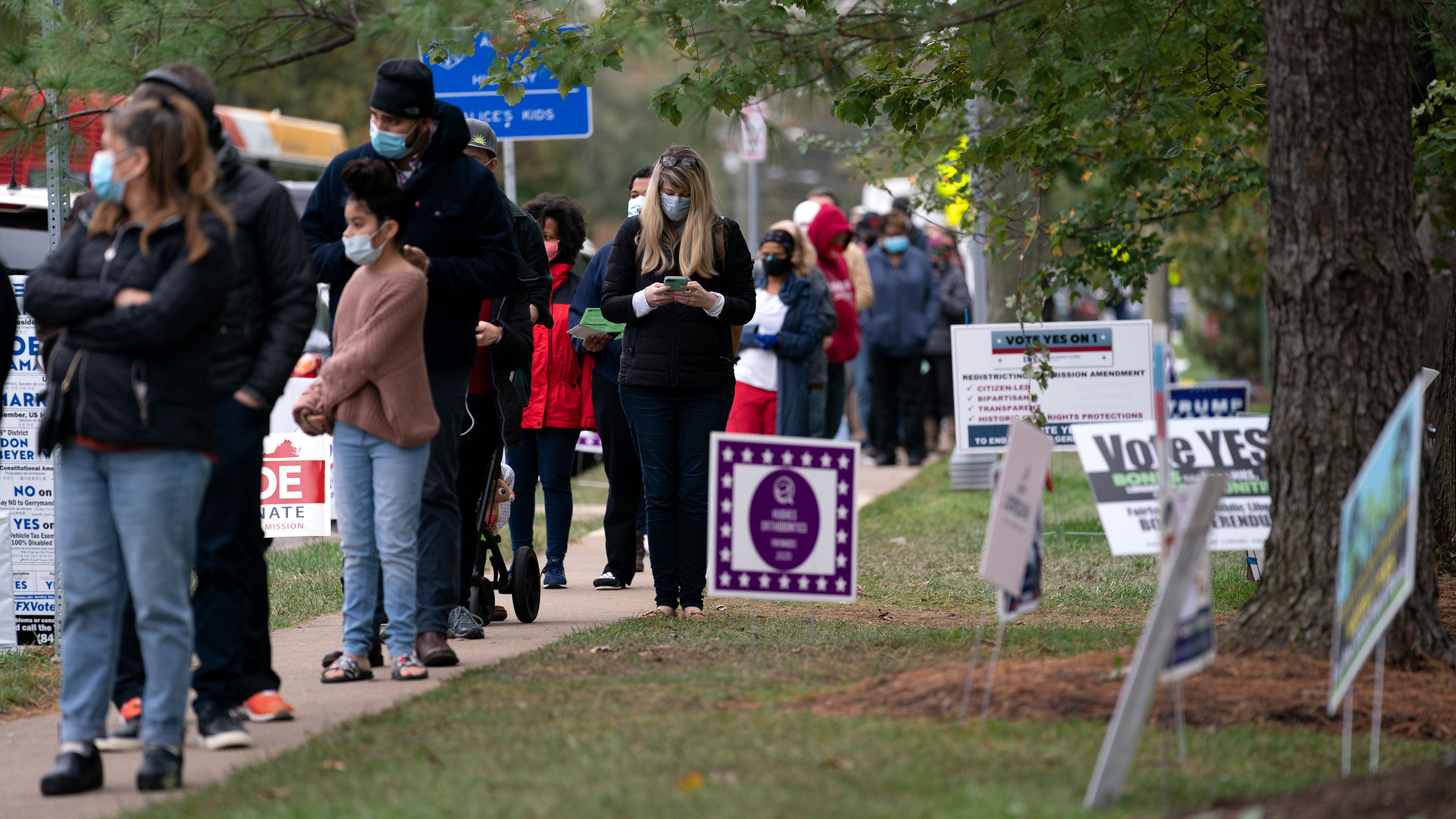 Voters wait in line to cast ballots at an early voting center in Alexandria, Virginia, on Sunday.