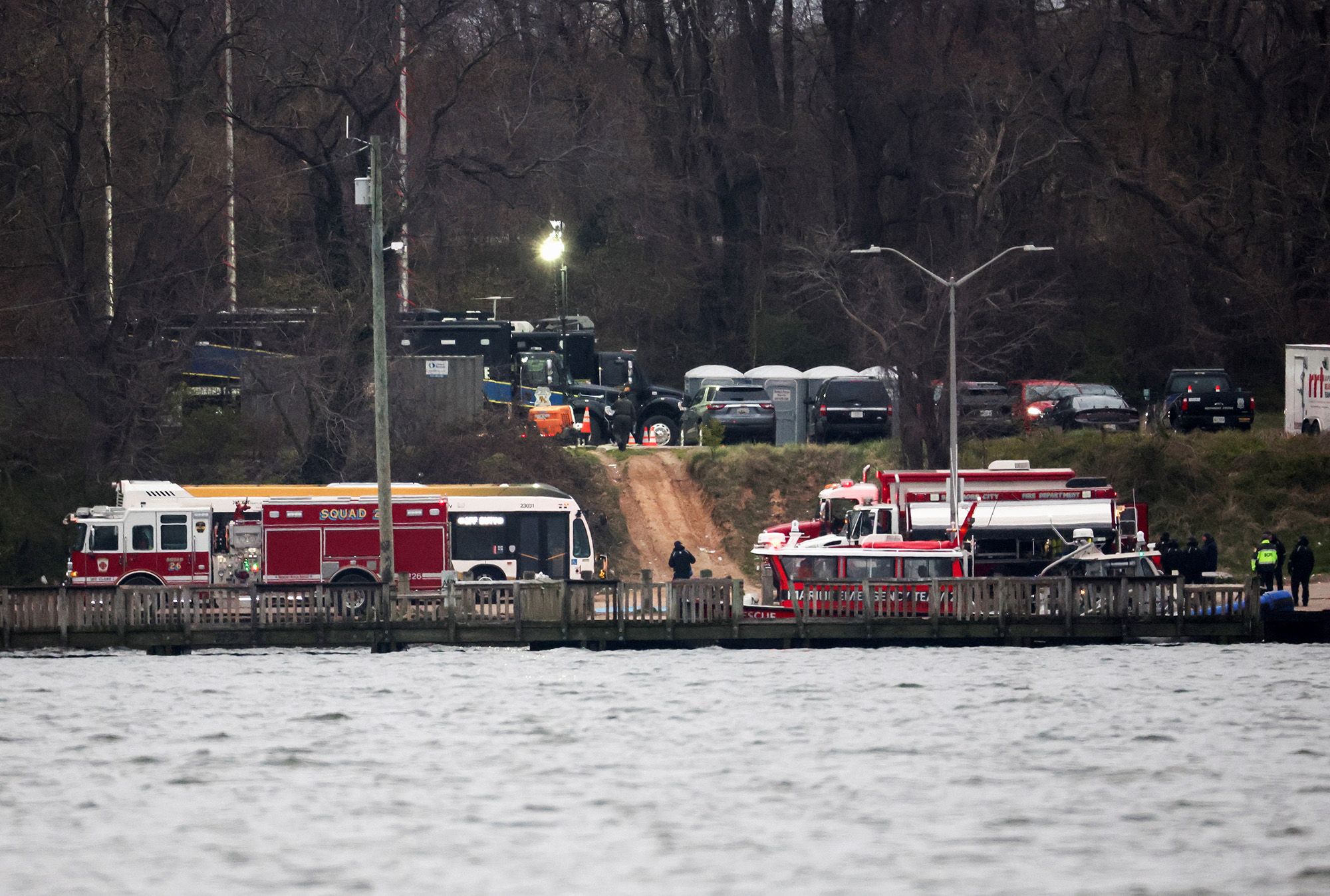 Emergency vehicles are parked near the scene of the Francis Scott Key Bridge collapse in Baltimore, Maryland, on March 27.