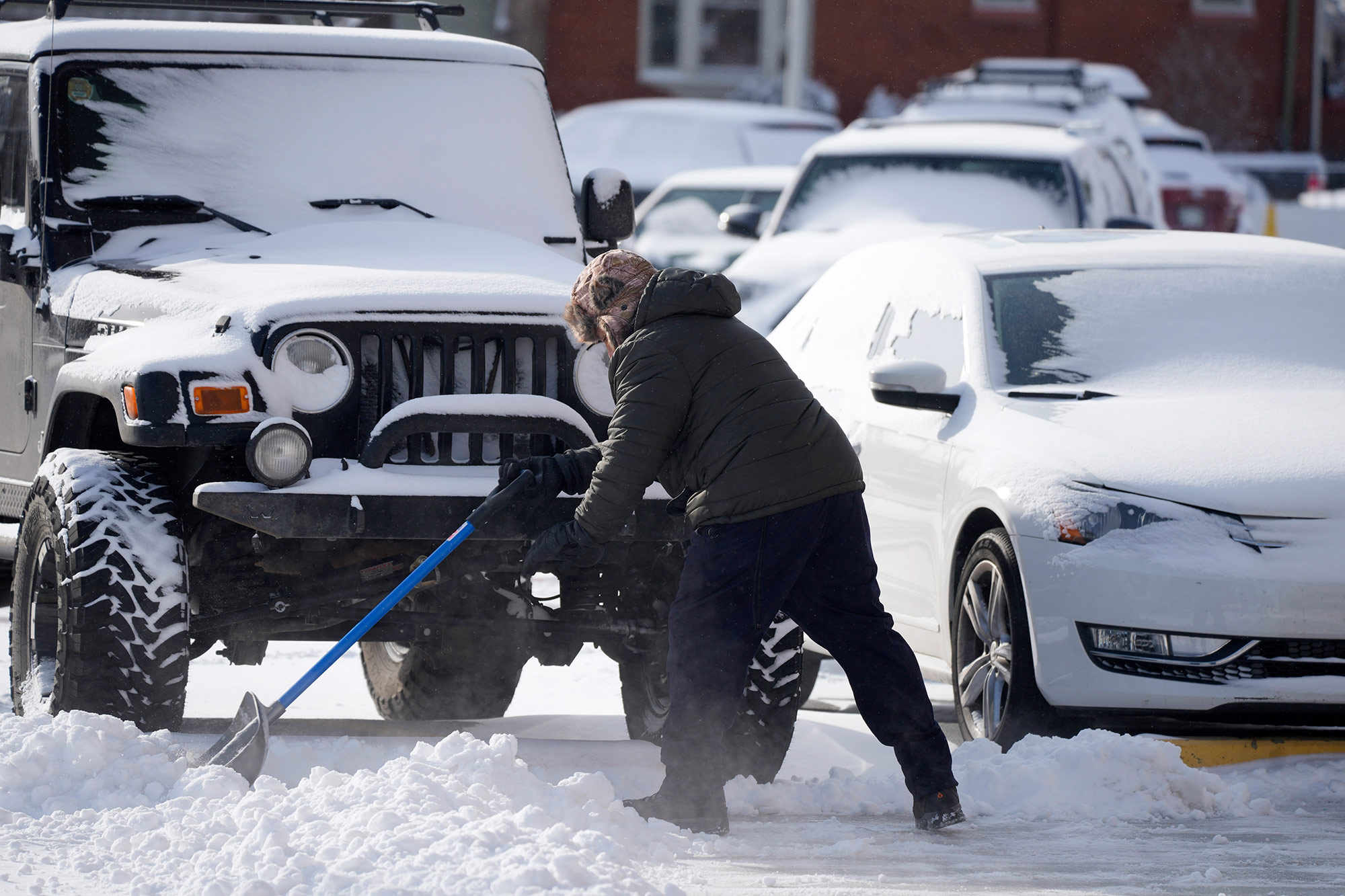 A man shovels snow on December 22, in Denver, Colorado. 