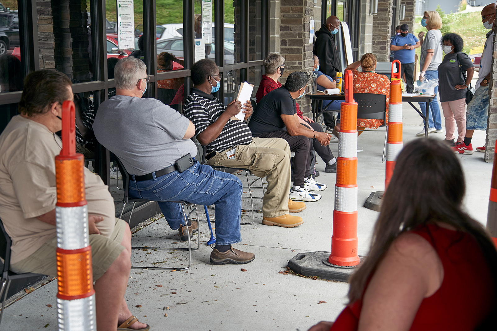Job seekers exercise social distancing as they wait to be called into the Heartland Workforce Solutions office in Omaha, Nebraska, on Wednesday, July 15.