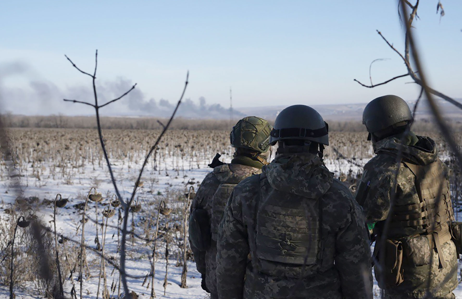 Ukrainian soldiers watch as smoke billows during fighting between Ukrainian and Russian forces in Soledar, Donetsk region on January 11. 
