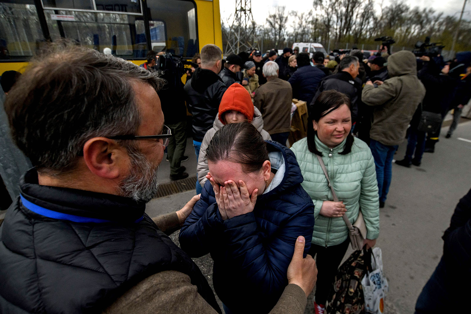 People fleeing fighting in Mariupol meet with relatives and friends as they arrive at a registration center for internally displaced people in Zaporizhzhia on April 21. They were part of a small convoy that was able to evacuate and cross through territory held by Russian forces.
